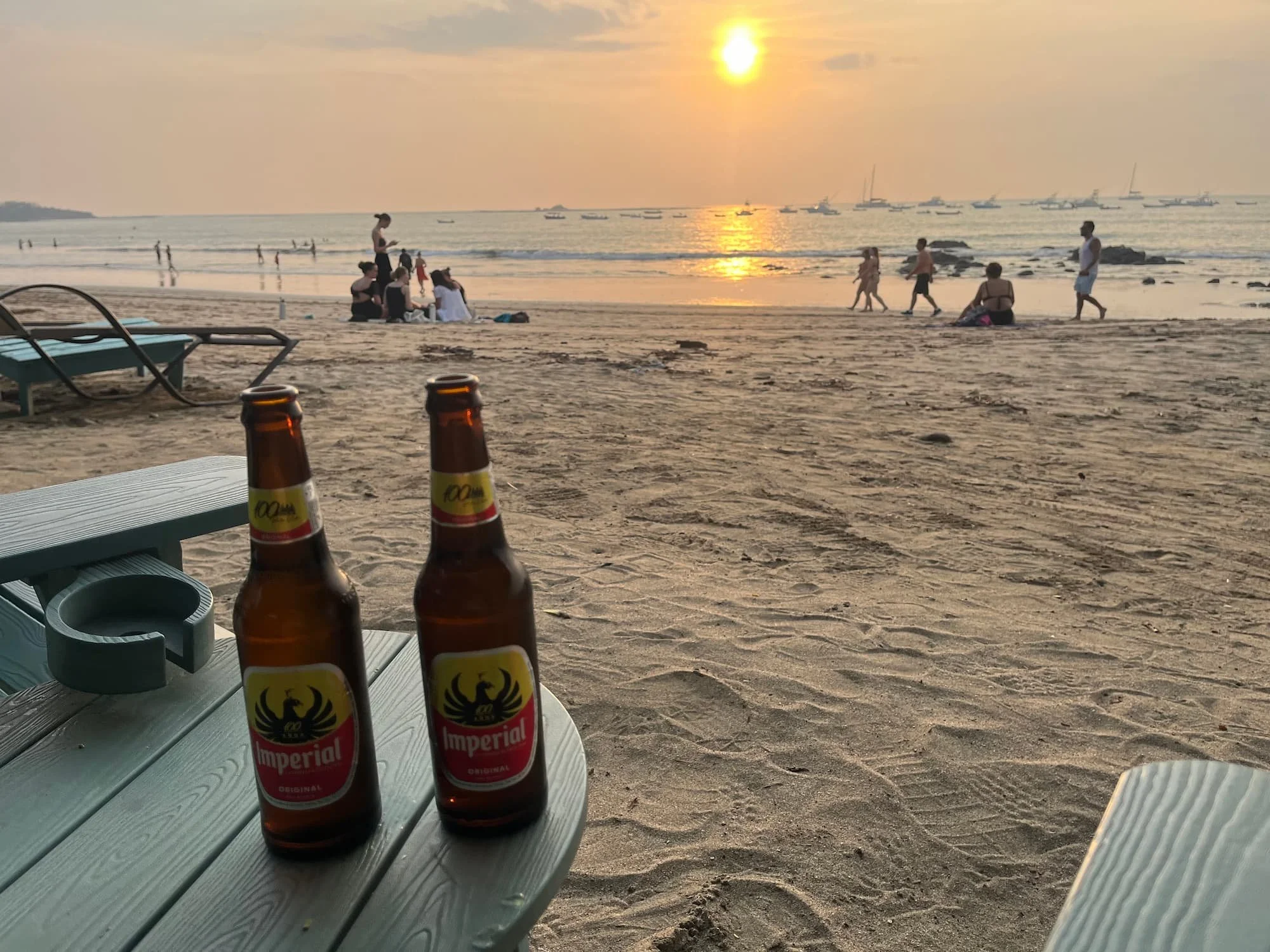 Two bottles of beer on Tamarindo beach in Costa Rica at sunset time in May