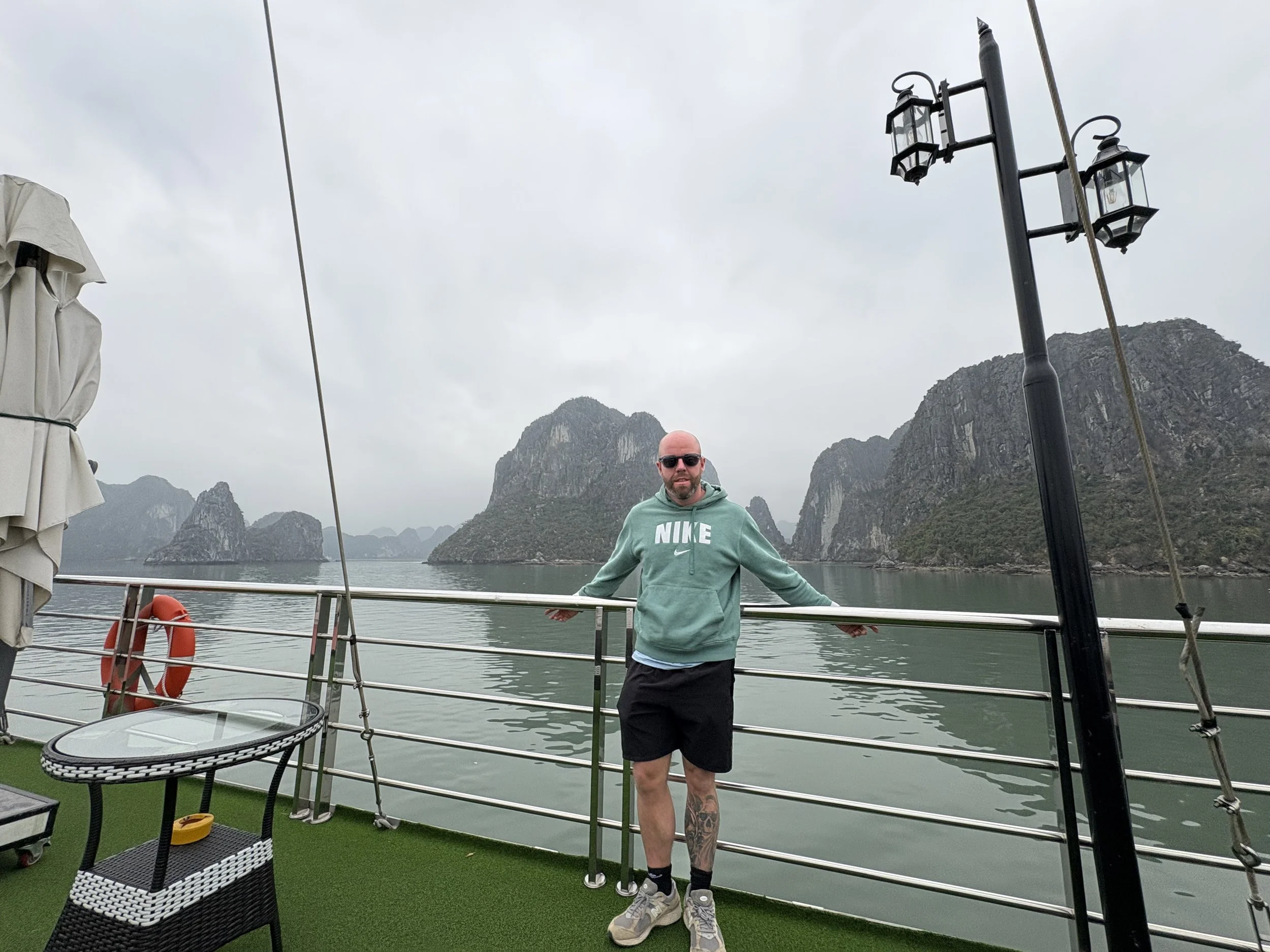 Tom Henty stood on a cruise ship at Ha Long Bay in Vietnam