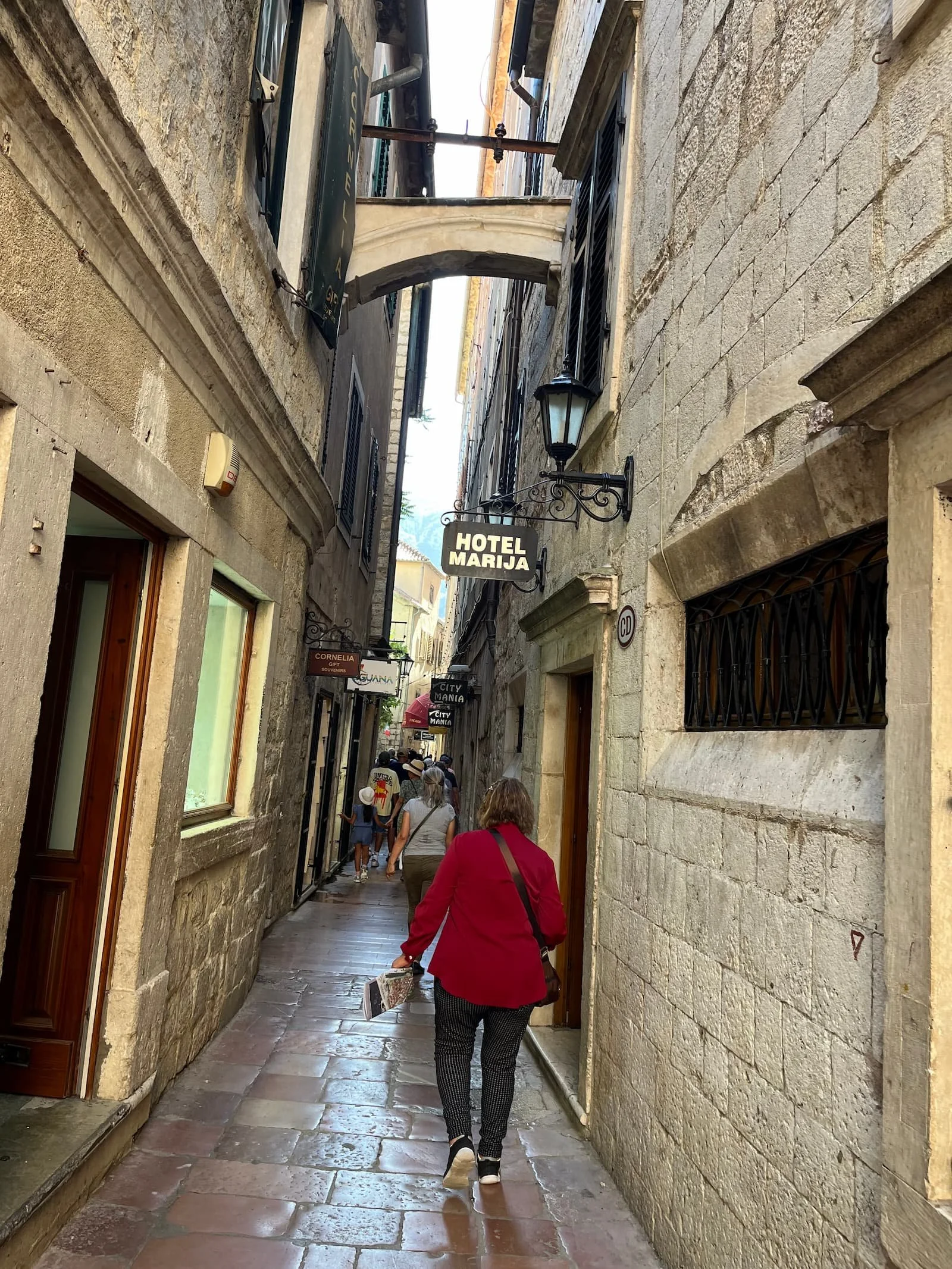 Walking down tight alley in Kotor Old Town in Montenegro