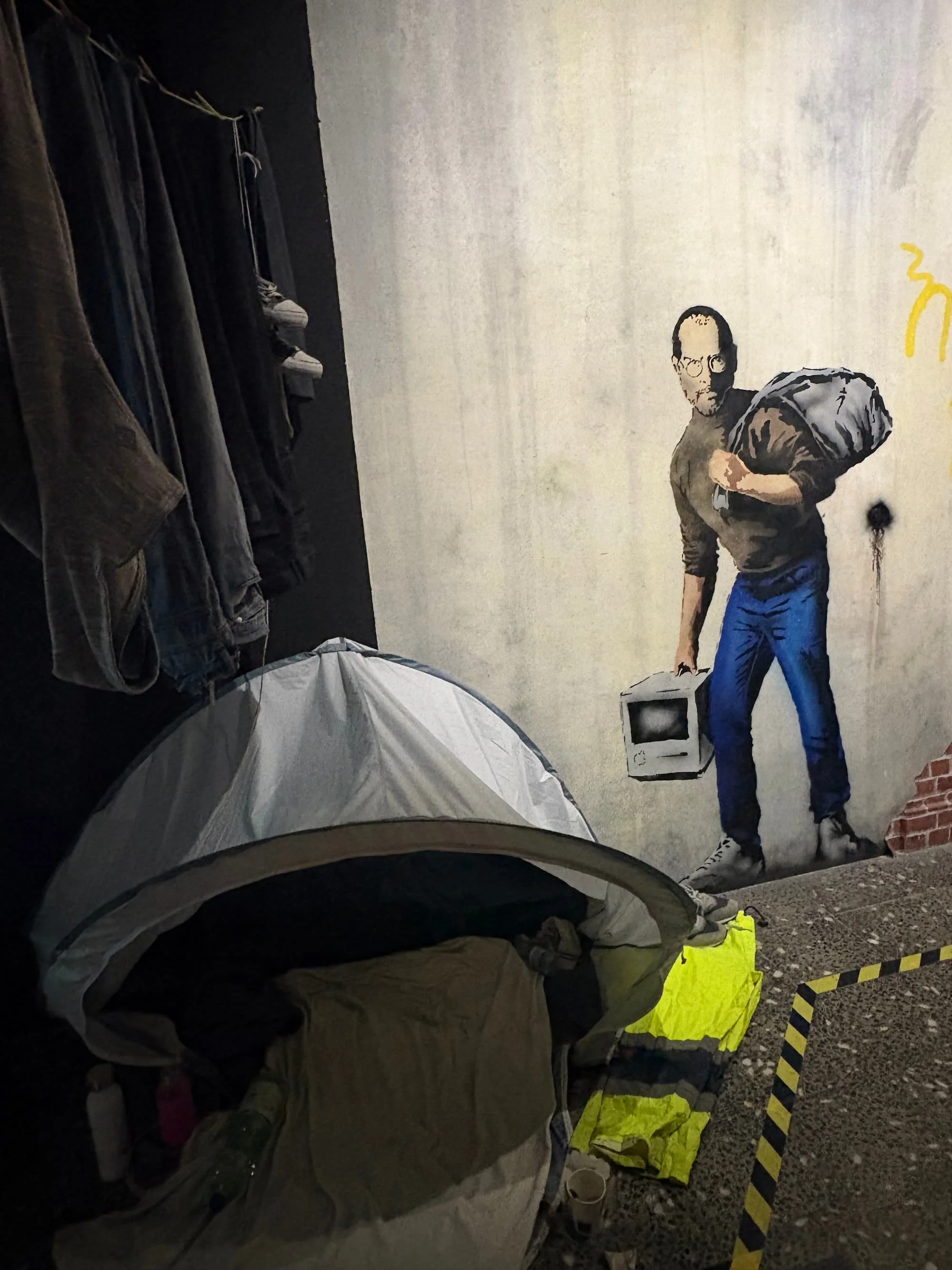 Artwork inspired by Banksy's Steve Jobs refugee mural at the Banksy Museum in Barcelona, highlighting the artist's thought-provoking social commentary.