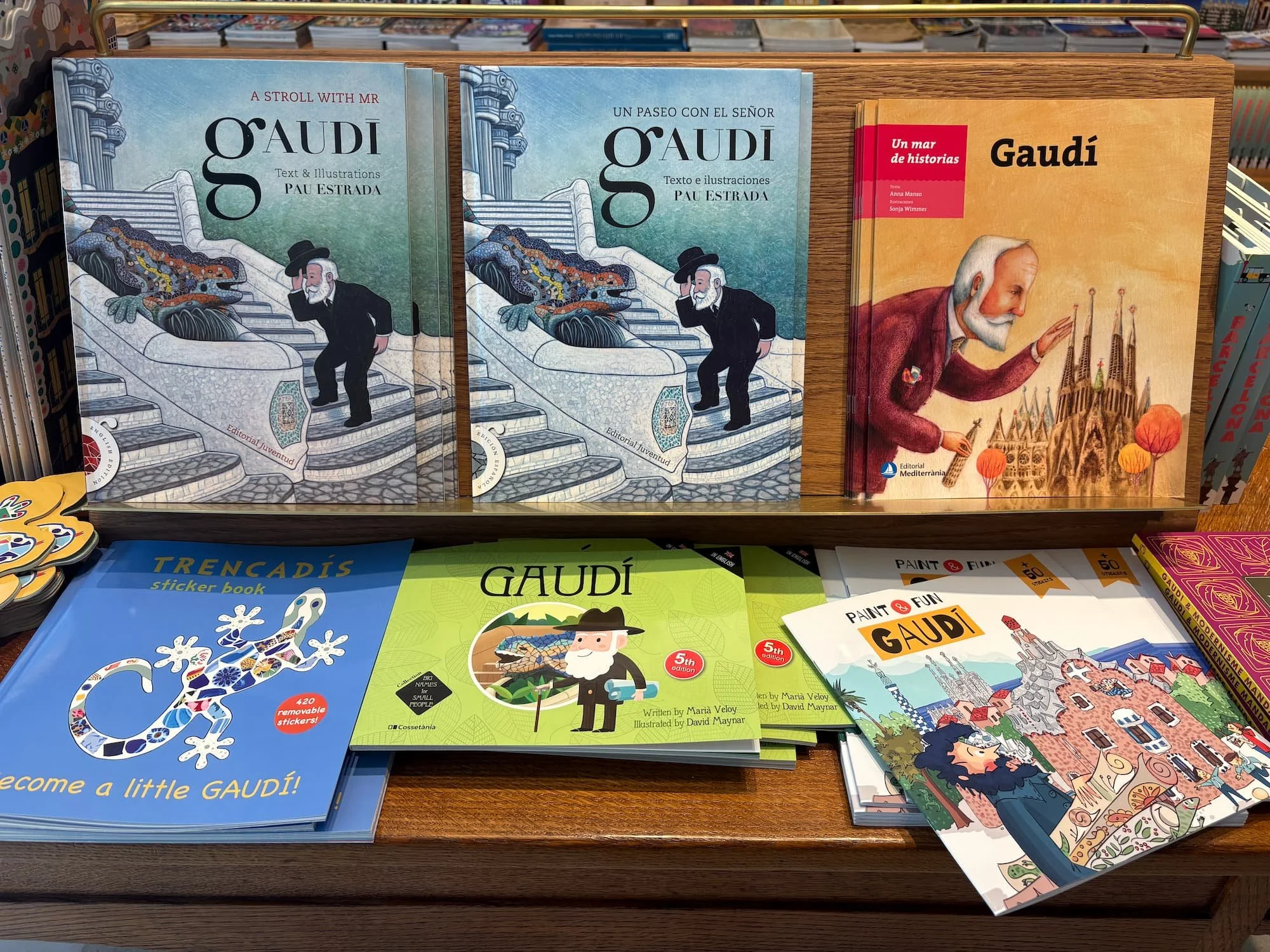 Books and souvenirs about Antoni Gaudí displayed inside the Casa Batlló gift shop in Barcelona