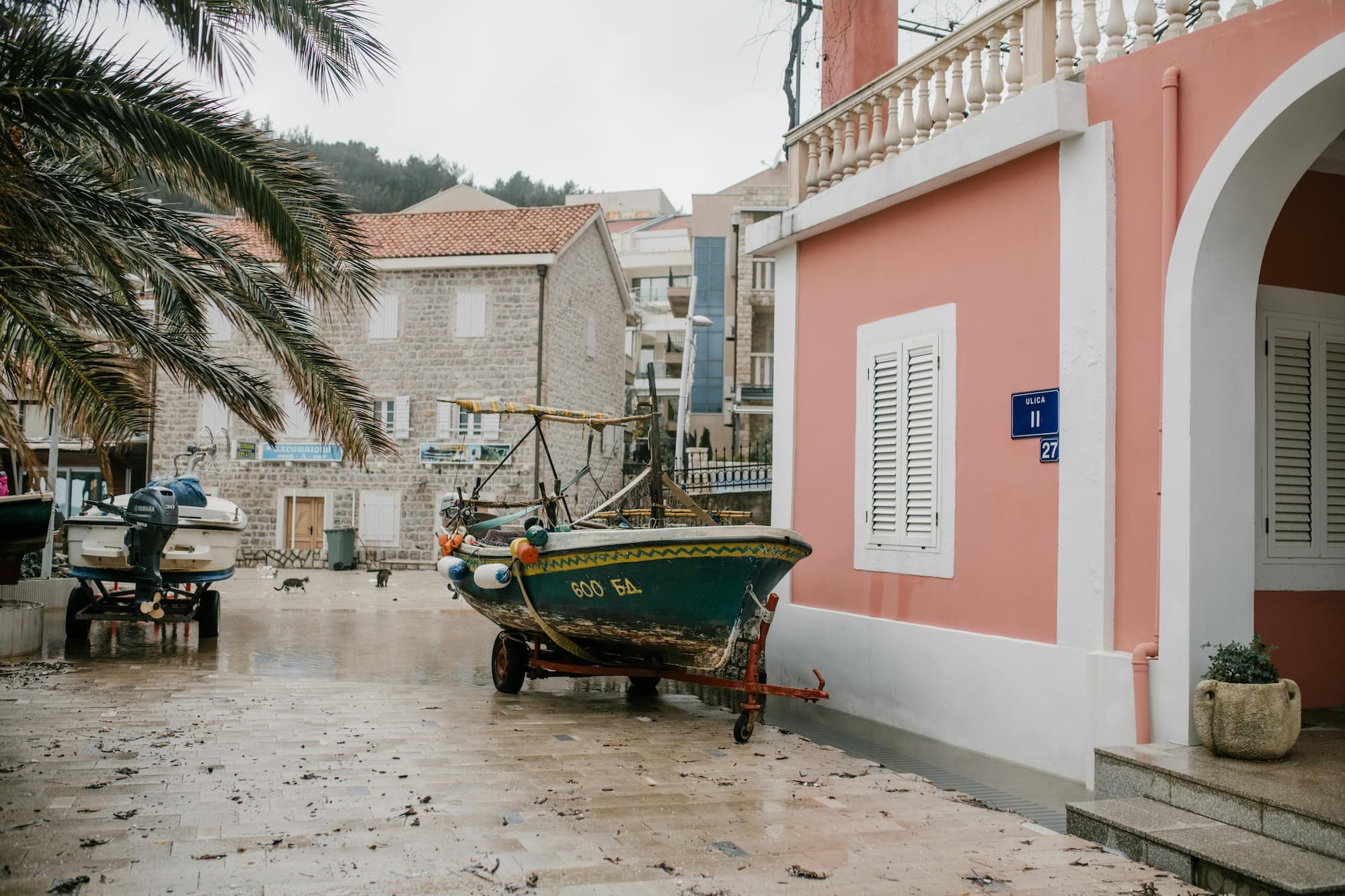 Pastel house and boat in Kotor in Montenegro