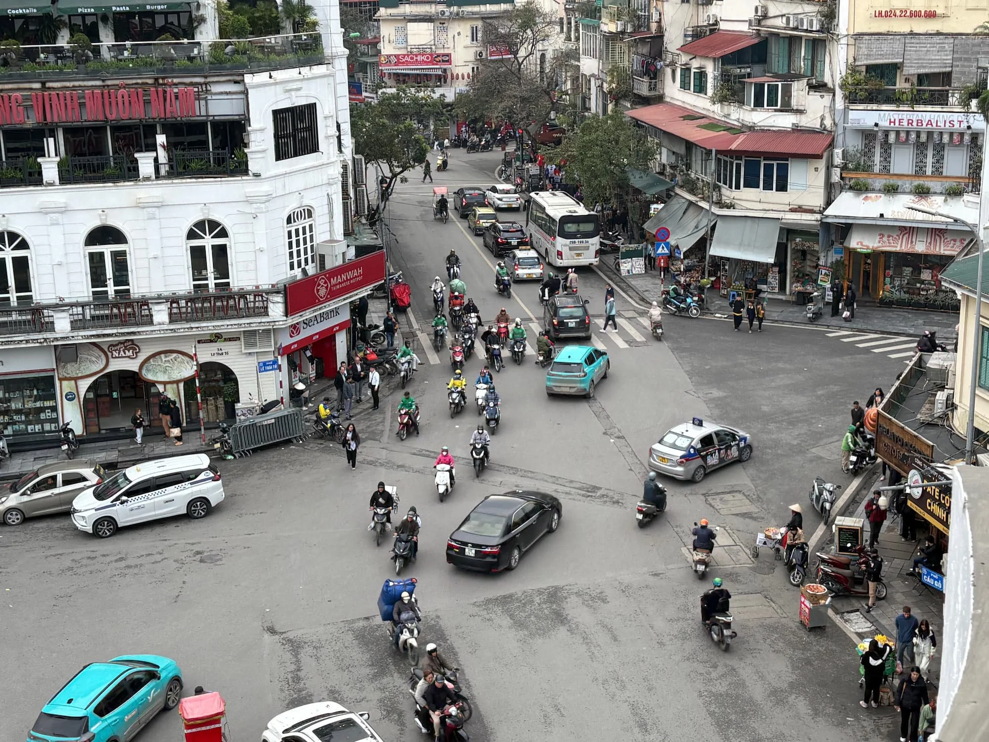 scooters filling a street in Hanoi Old Quarter in VIetnam