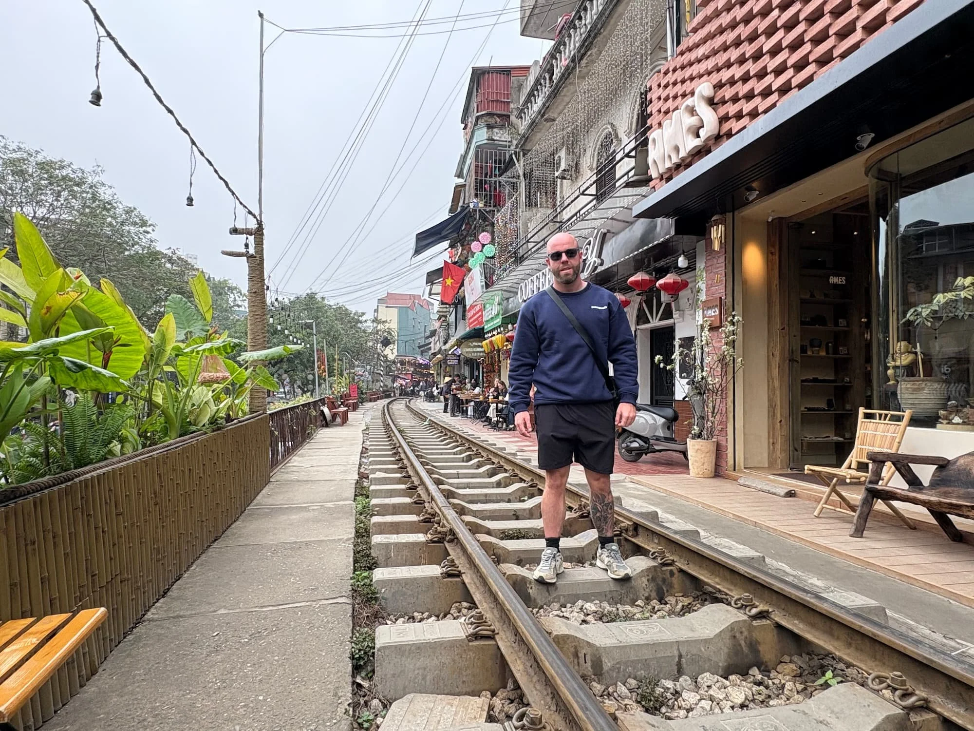 Tom Henty stood on tracks at Train Street in Hanoi in Vietnam