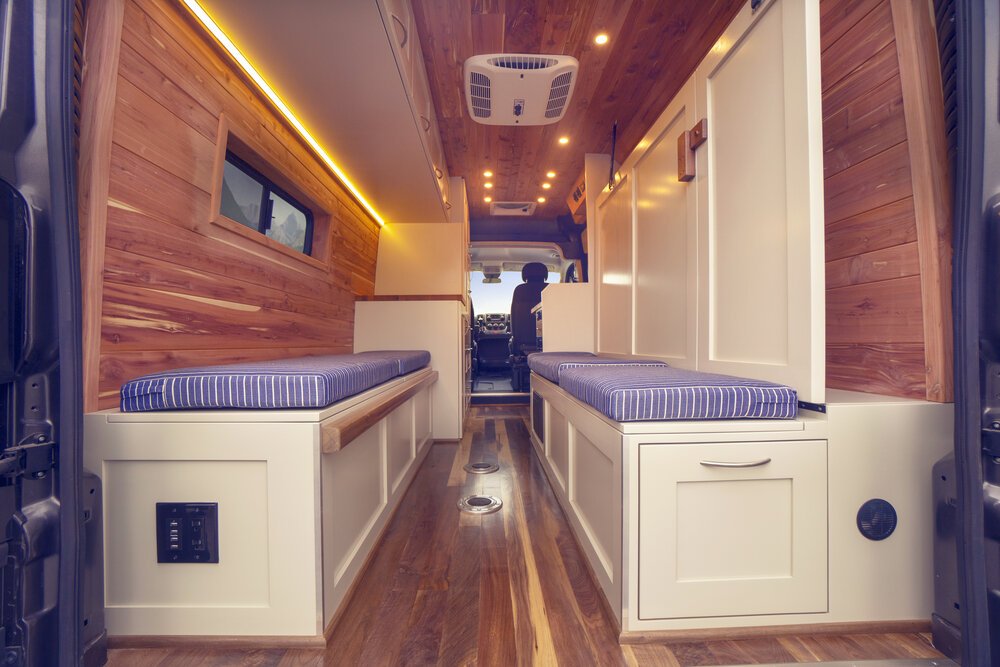 A Off Grid Adventure Vans base layout - Rambler. A "Murphy Bed" system with extra seating and storage benches with stow away bed.