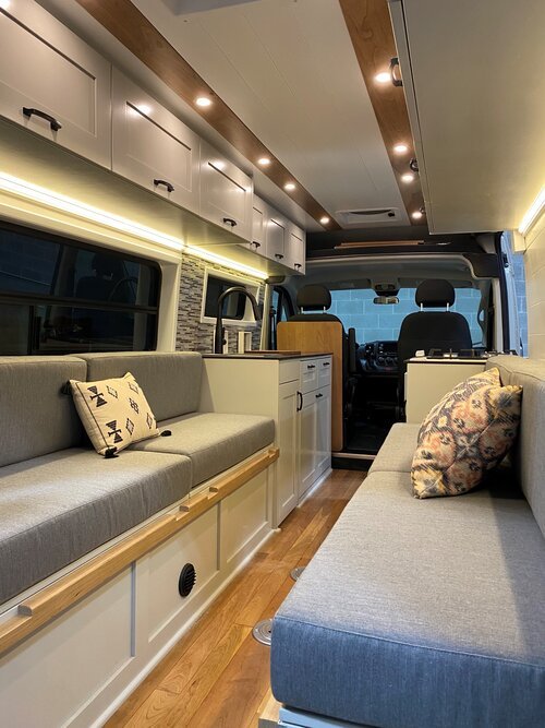 A Off Grid Adventure Vans base layout - Sandstone. Bench to Bed System with clean design and superior function.
