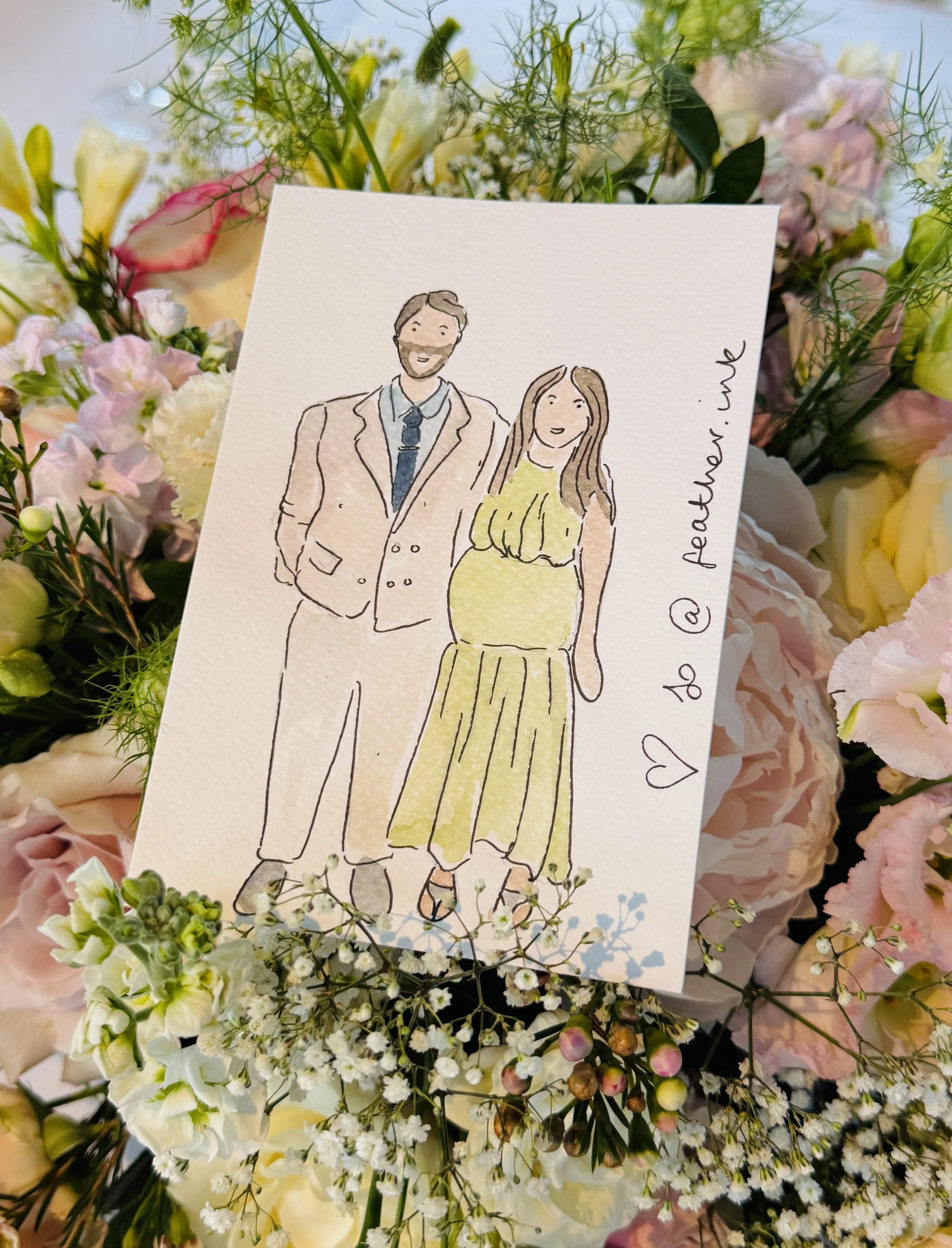 A wedding or celebration card with a watercolour illustration of a man in a suit with a beard and a woman in a yellow dress, surrounded by a colorful bouquet of flowers.