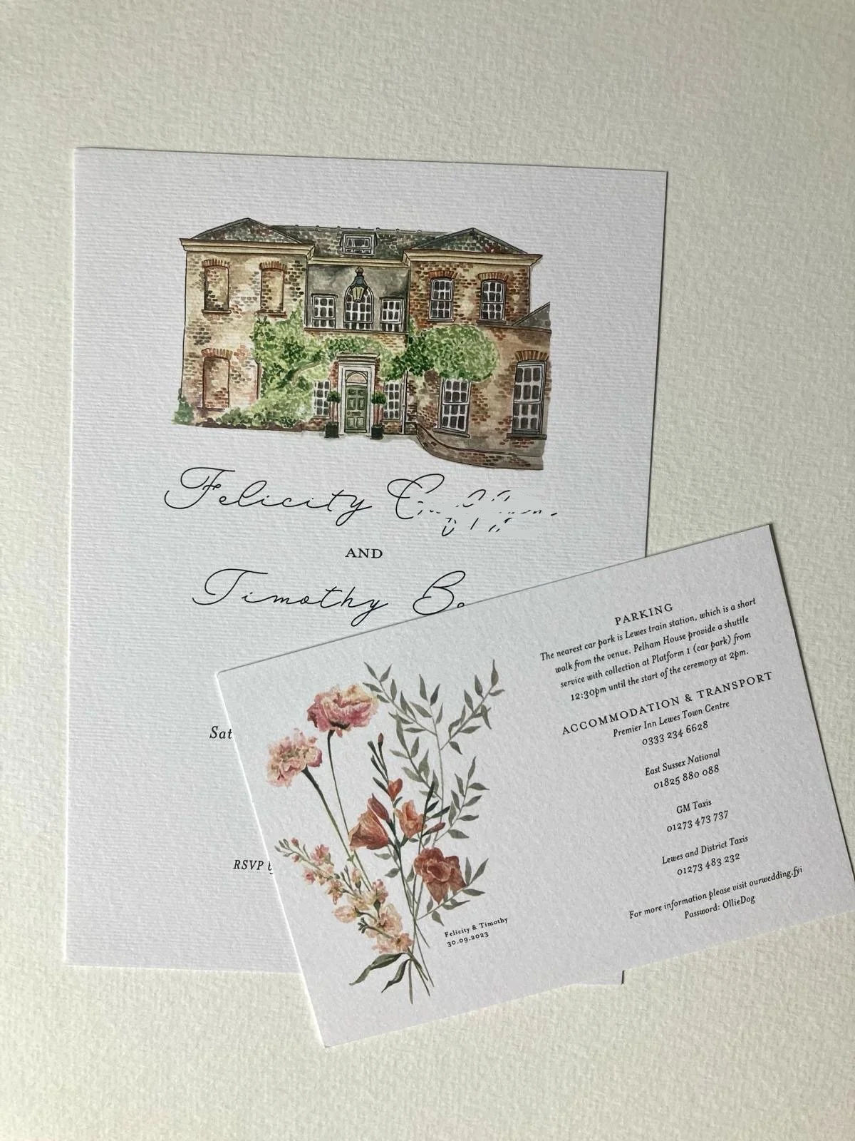 Hand-painted wedding invitation featuring delicate botanical artwork and venue painting