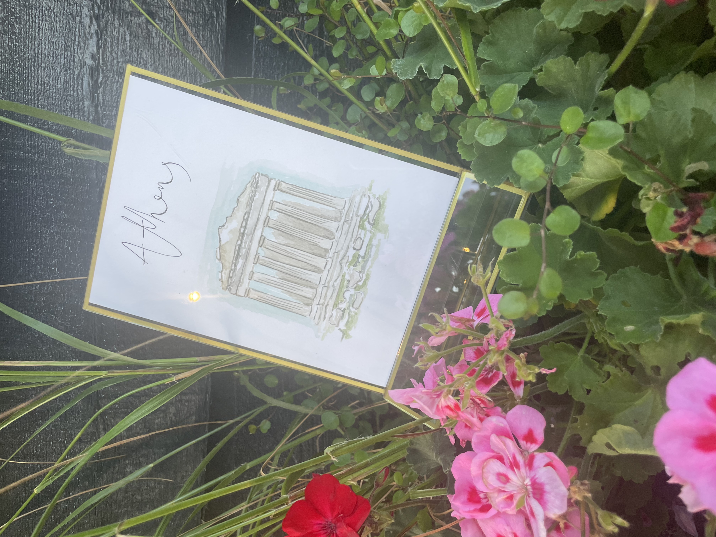 Illustrated wedding table stationery featuring hand-painted artwork of locations