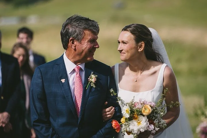 The halfway-down-the-aisle dip with your partner is always a crowd favorite, but don&rsquo;t forget the glance toward your mom or dad if they are walking you down. As a parent, I can promise that in that moment they see every version of their child w