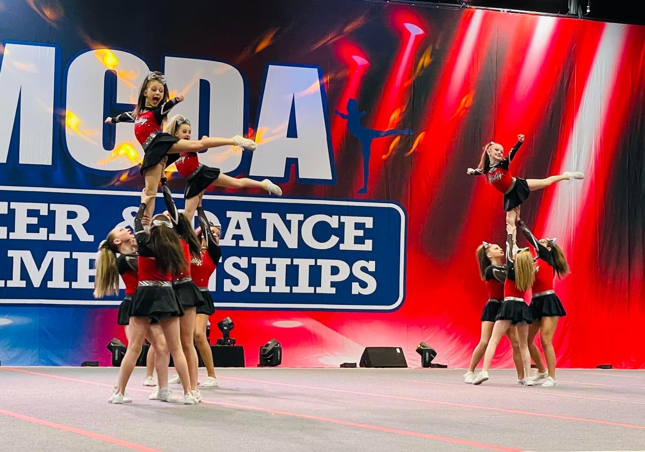 Working hard with my team at cheer competition.