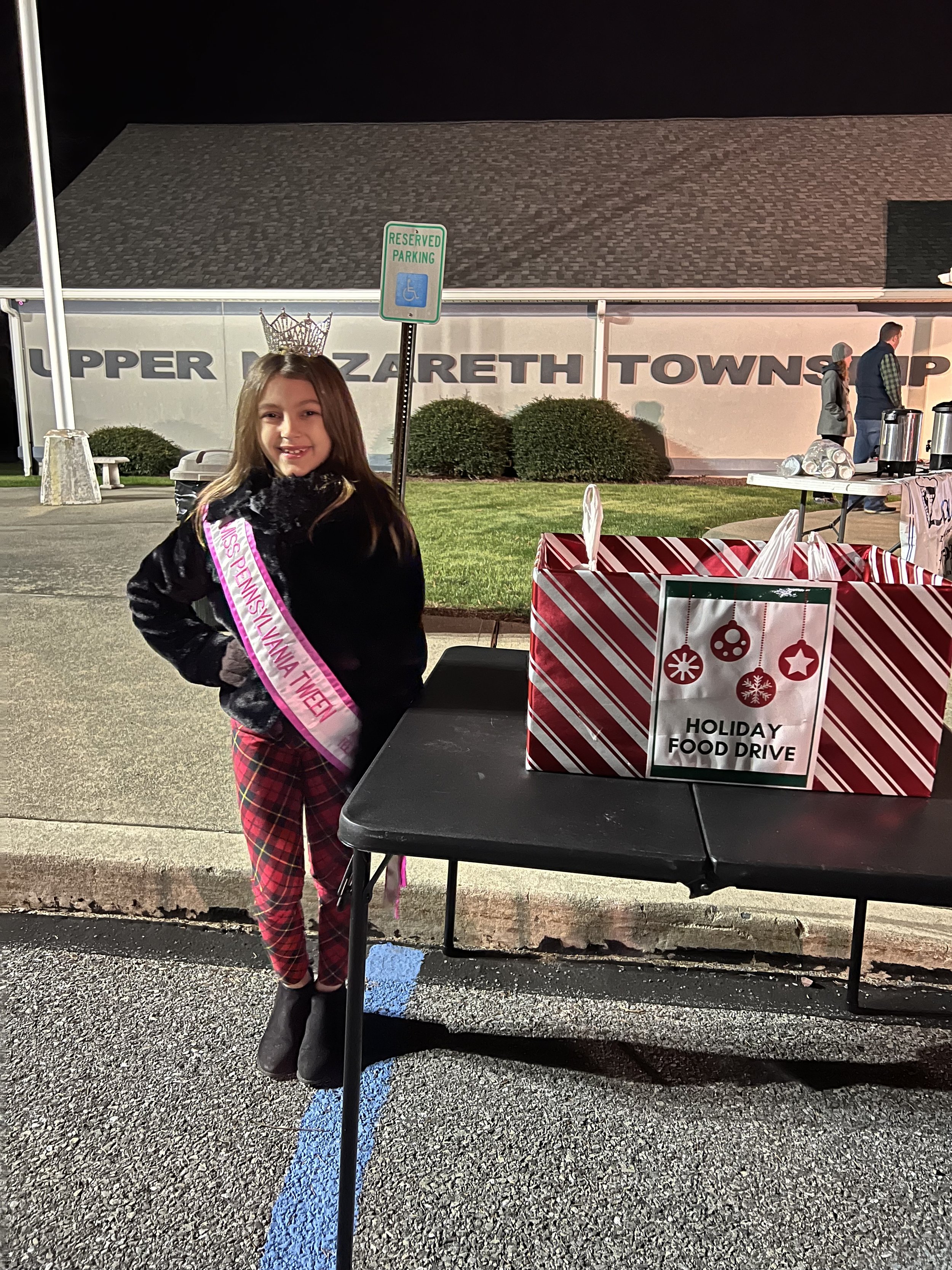 Volunteering at Upper Nazareth Christmas celebration collecting food donations for the Nazareth Food Bank.