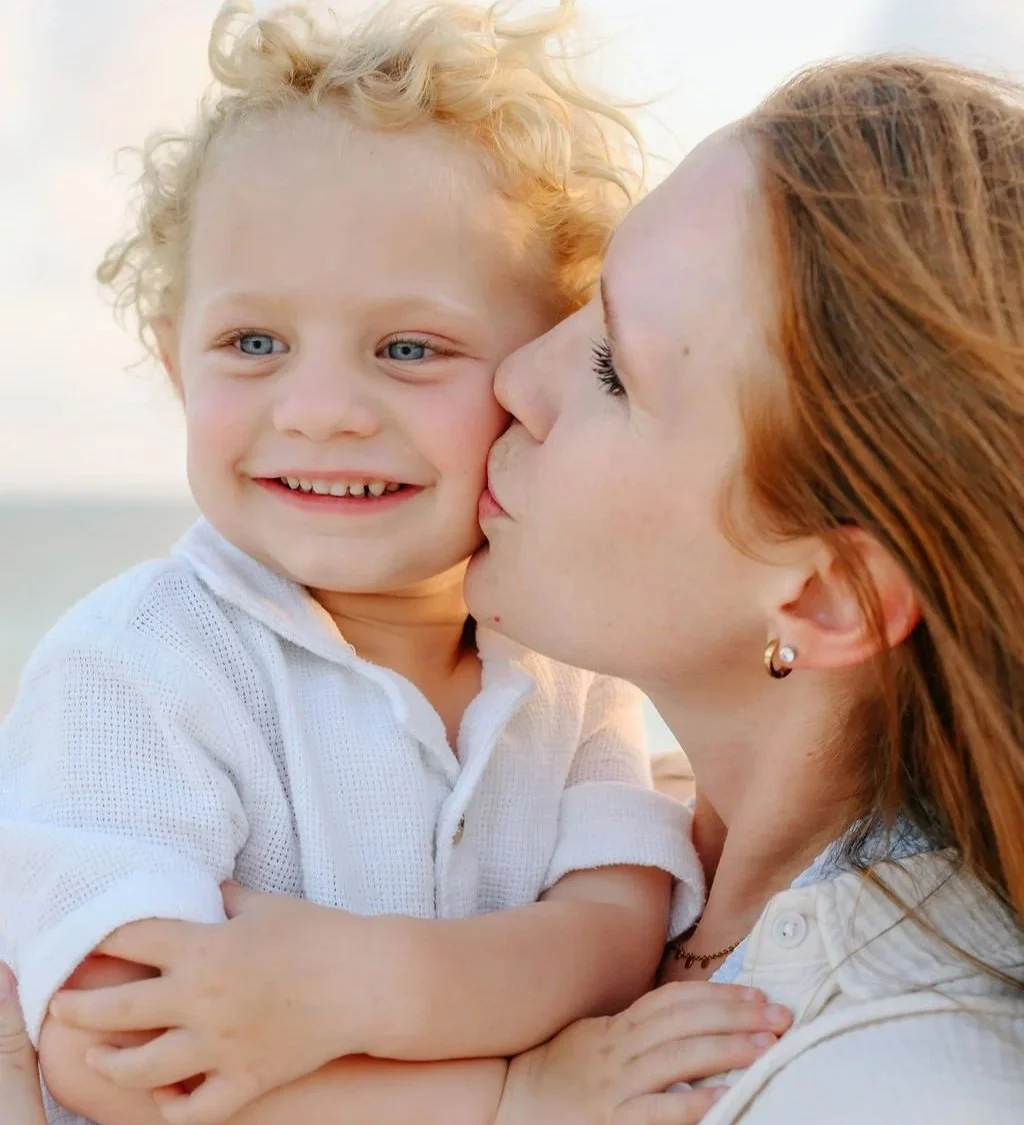 Mother kissing her son, family portrait, grand cayman photographer