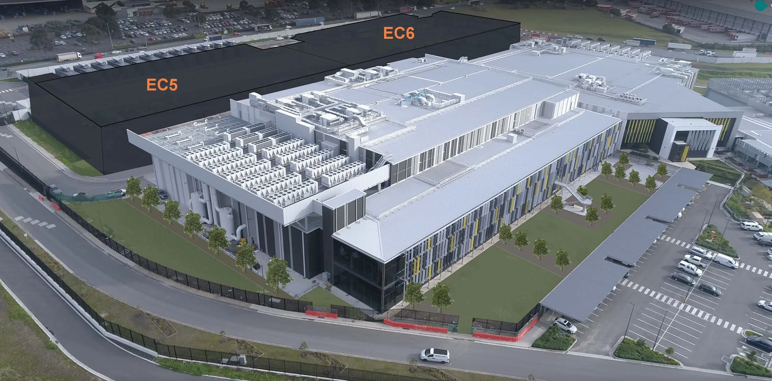 An aerial view of a large modern building with labeled sections EC5 and EC6, surrounded by parking lots, trees, and roads.