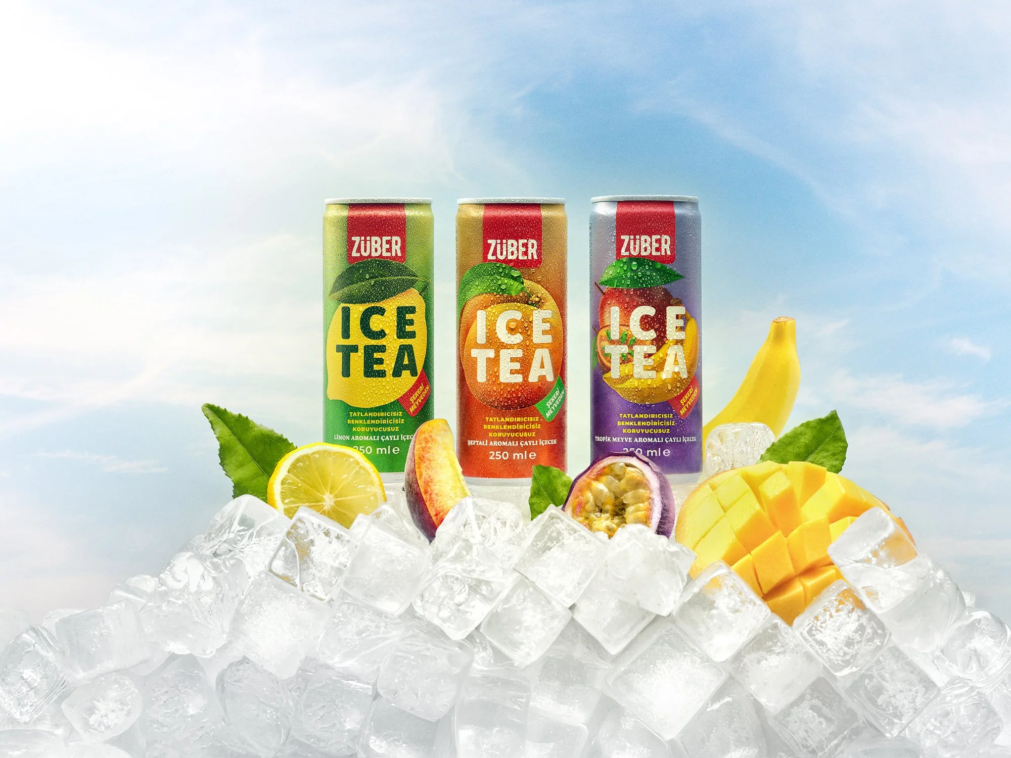 Three cans of ice tea flavored drinks with fruit illustrations, placed on ice cubes with lemon, peach, passion fruit, mango, and banana fruits around them, under a blue sky.