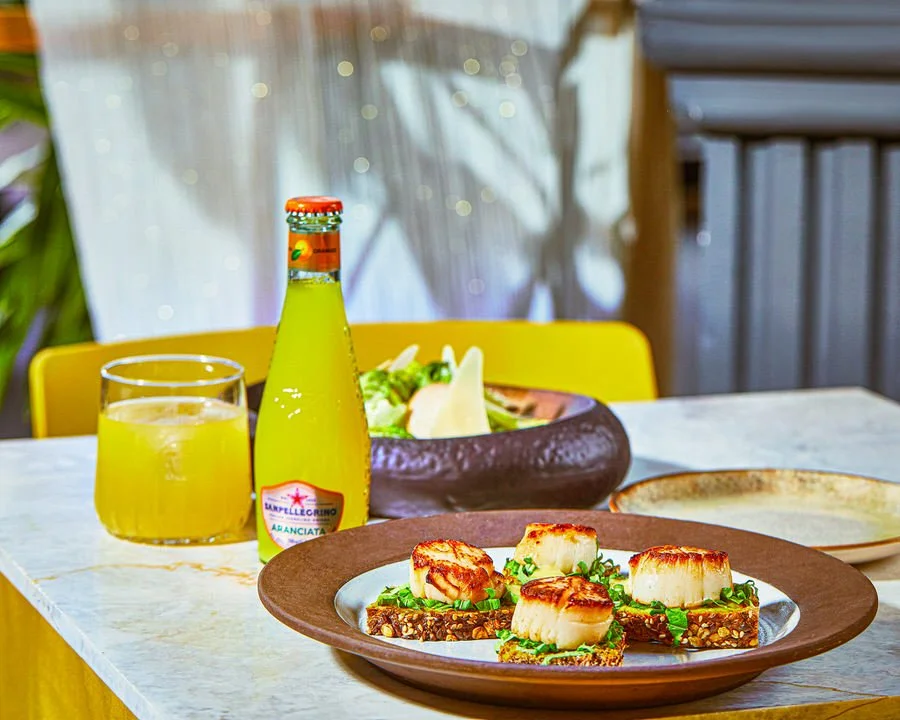 Çeşitli deniz ürünleri ve gurme yemeklerin bulunduğu masa düzeni.


