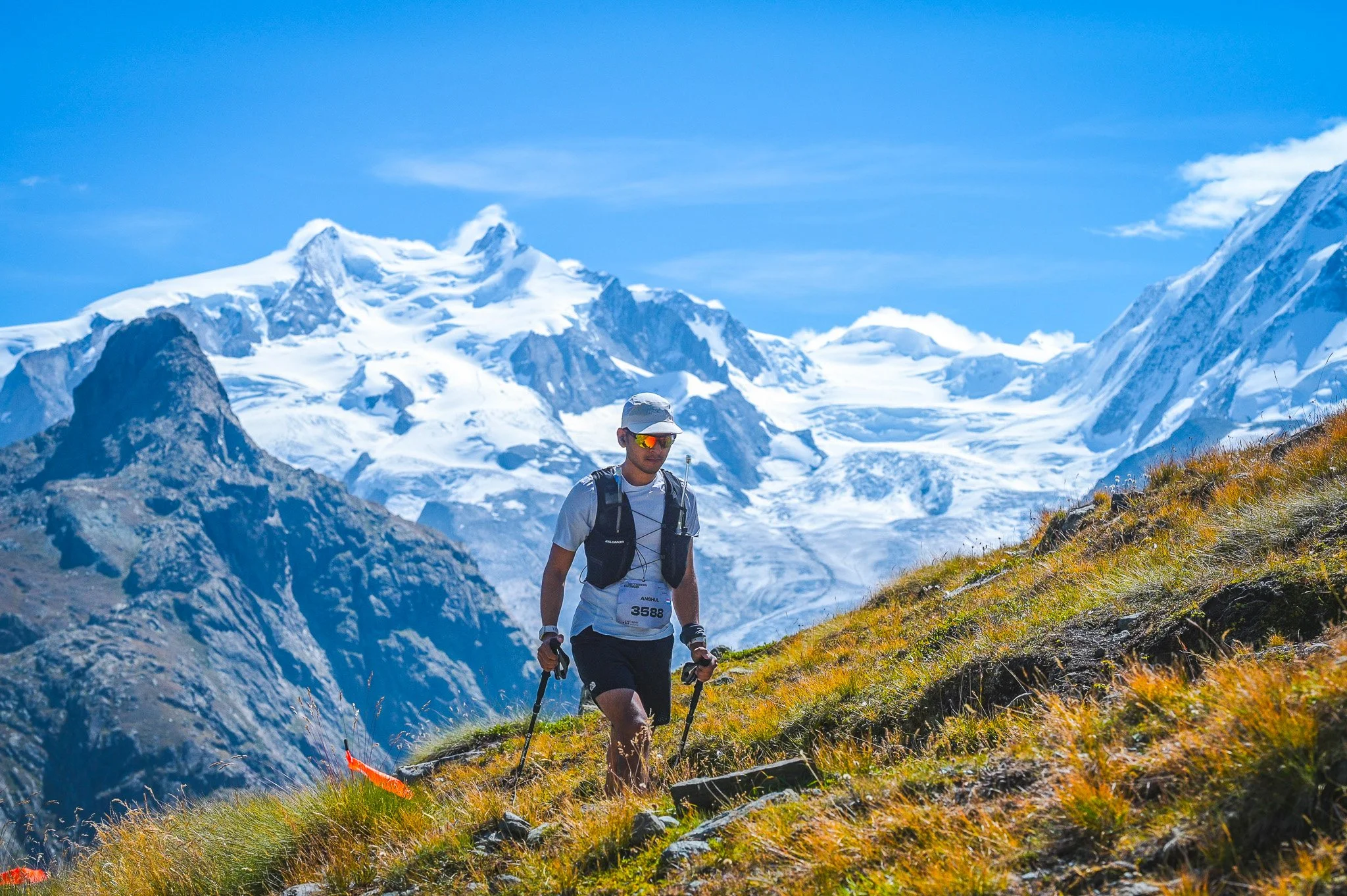 Trail runner with Swiss Alps in the background