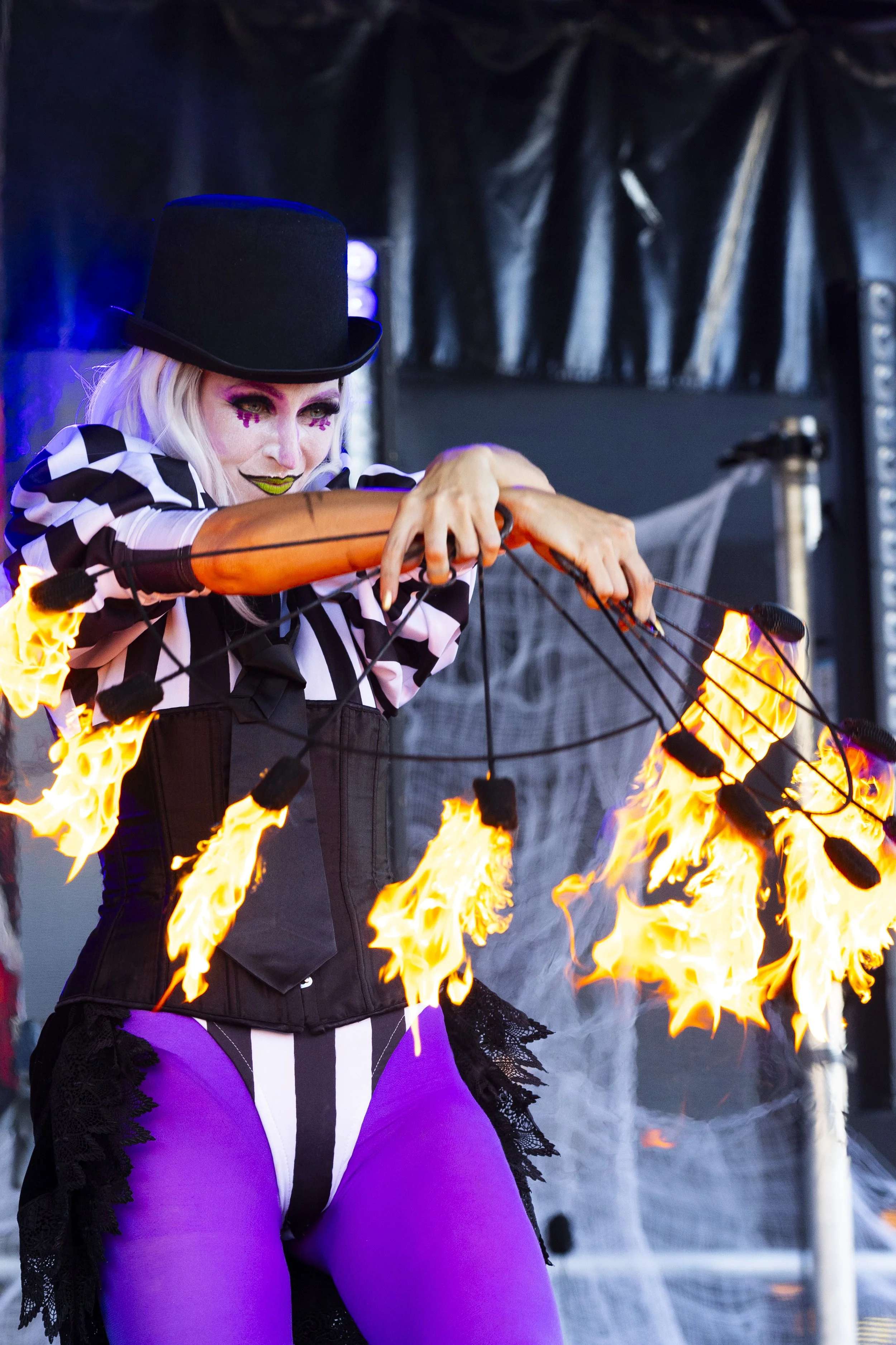 Flaming head act during outdoor Halloween celebration in Brisbane