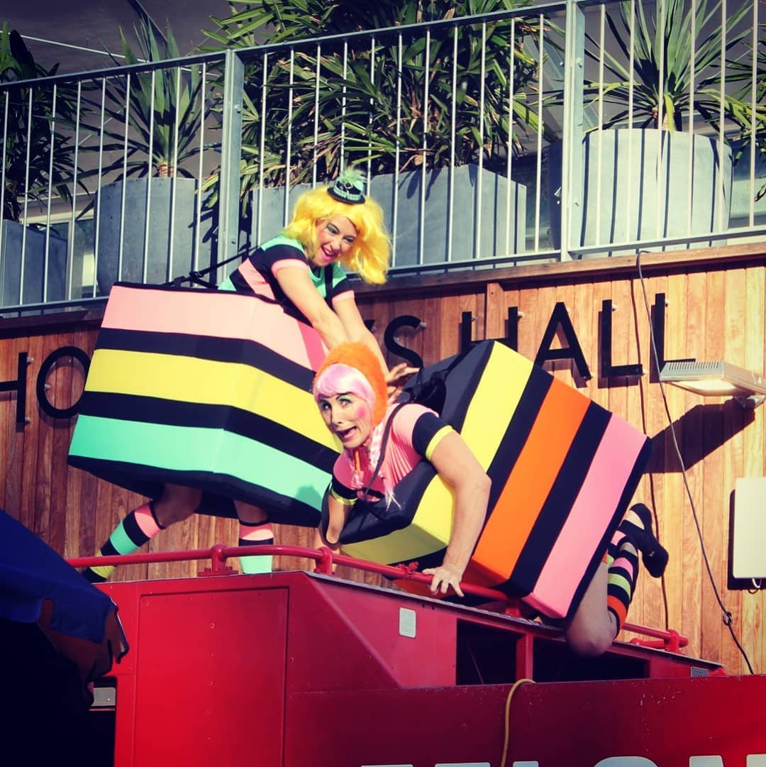 Striped liquorice characters walking through parade route engaging families on the Gold Coast.