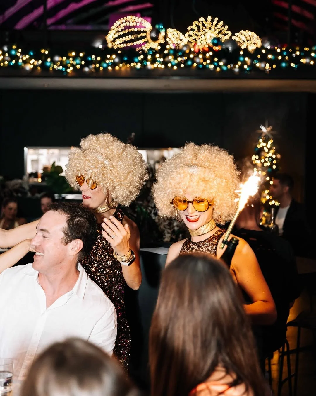 Disco diva roving performer posing with guest at corporate party.