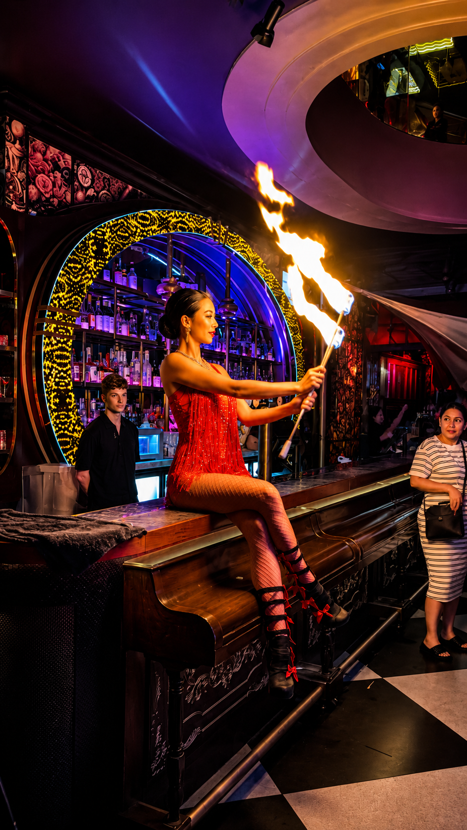 Fire performer entertaining guests on a nightclub bar in Brisbane.
