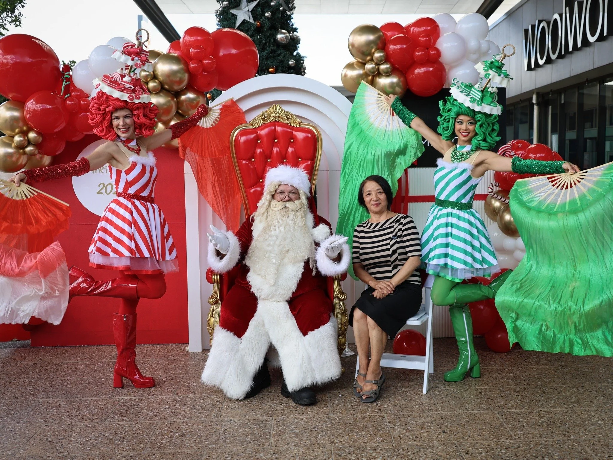 Santa and colourful candy characters entertaining families at South Bank Christmas event.