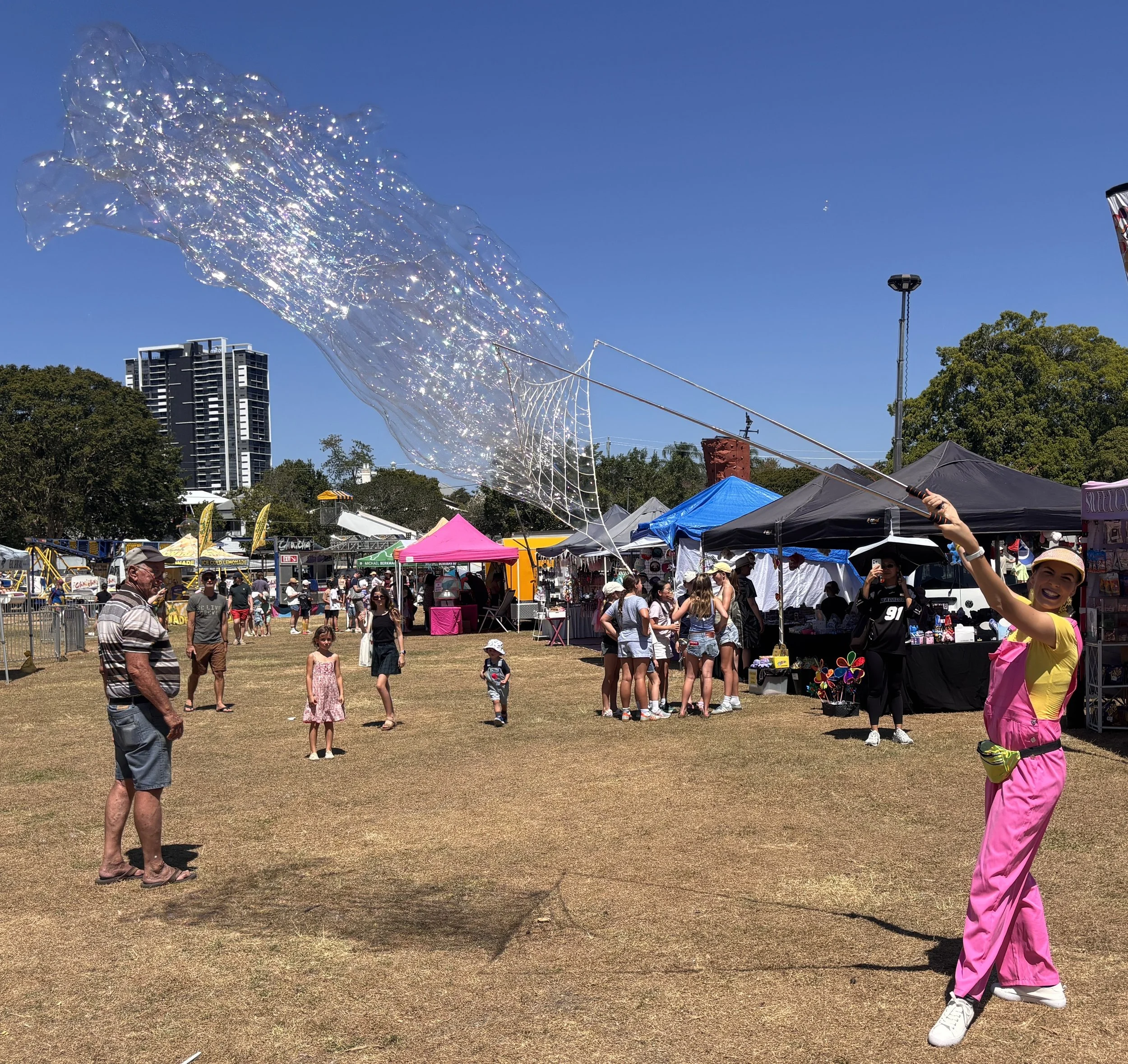 Bubble artist making giant bubbles at Brisbane community festival
