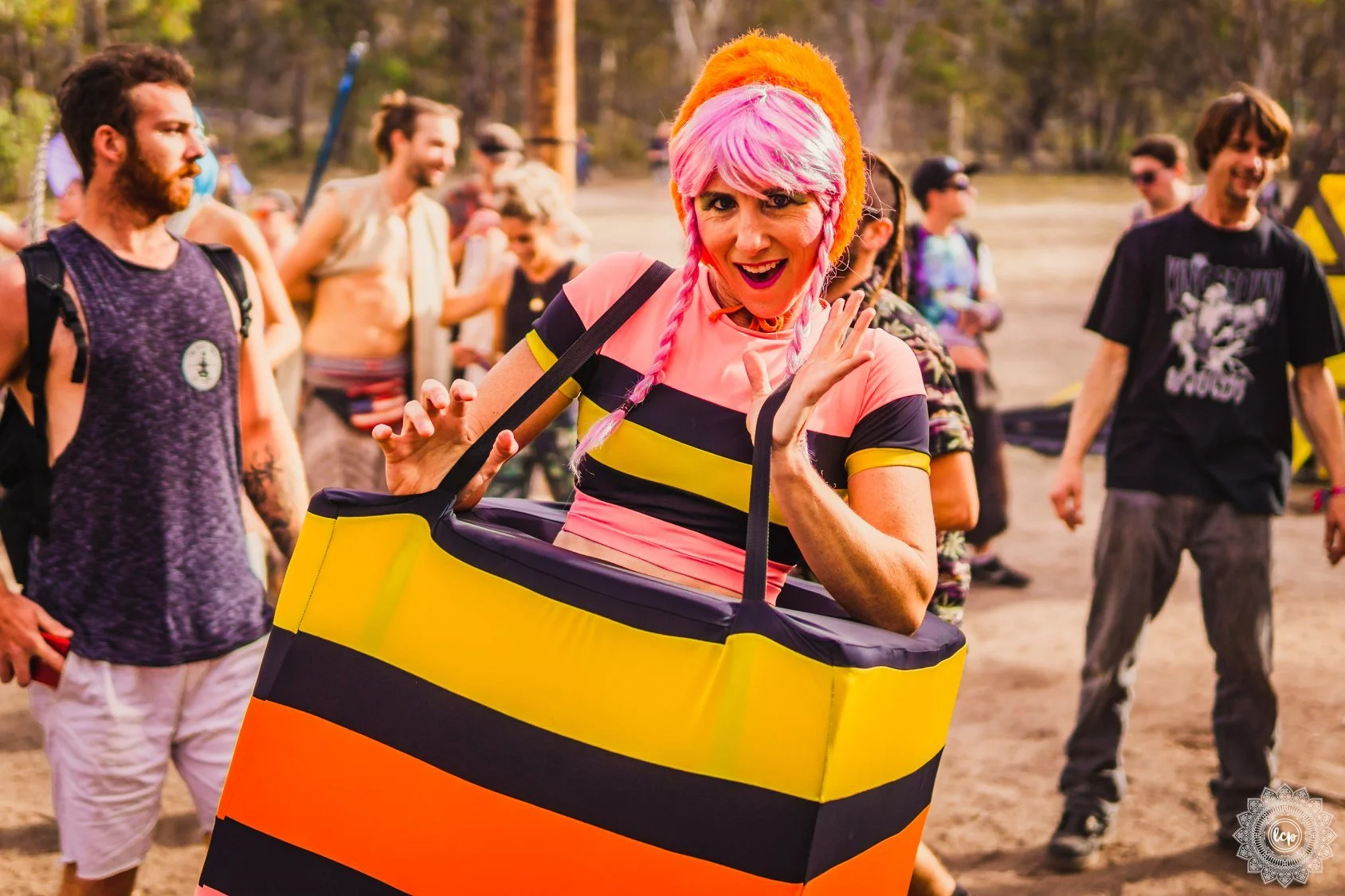 Colourful liquorice allsorts roving characters entertaining crowds at Brisbane festival with playful interaction and photo moments.
