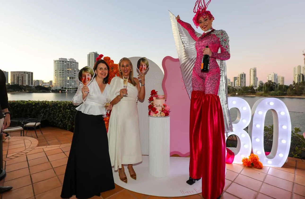 Pink stilt walker pouring champagne private party Gold Coast