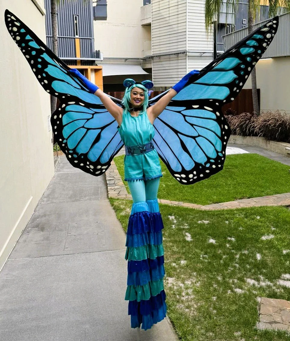 Eyes Up Events, blue butterfly with big wings stilt walker, nature themed event, roving entertainment Brisbane
