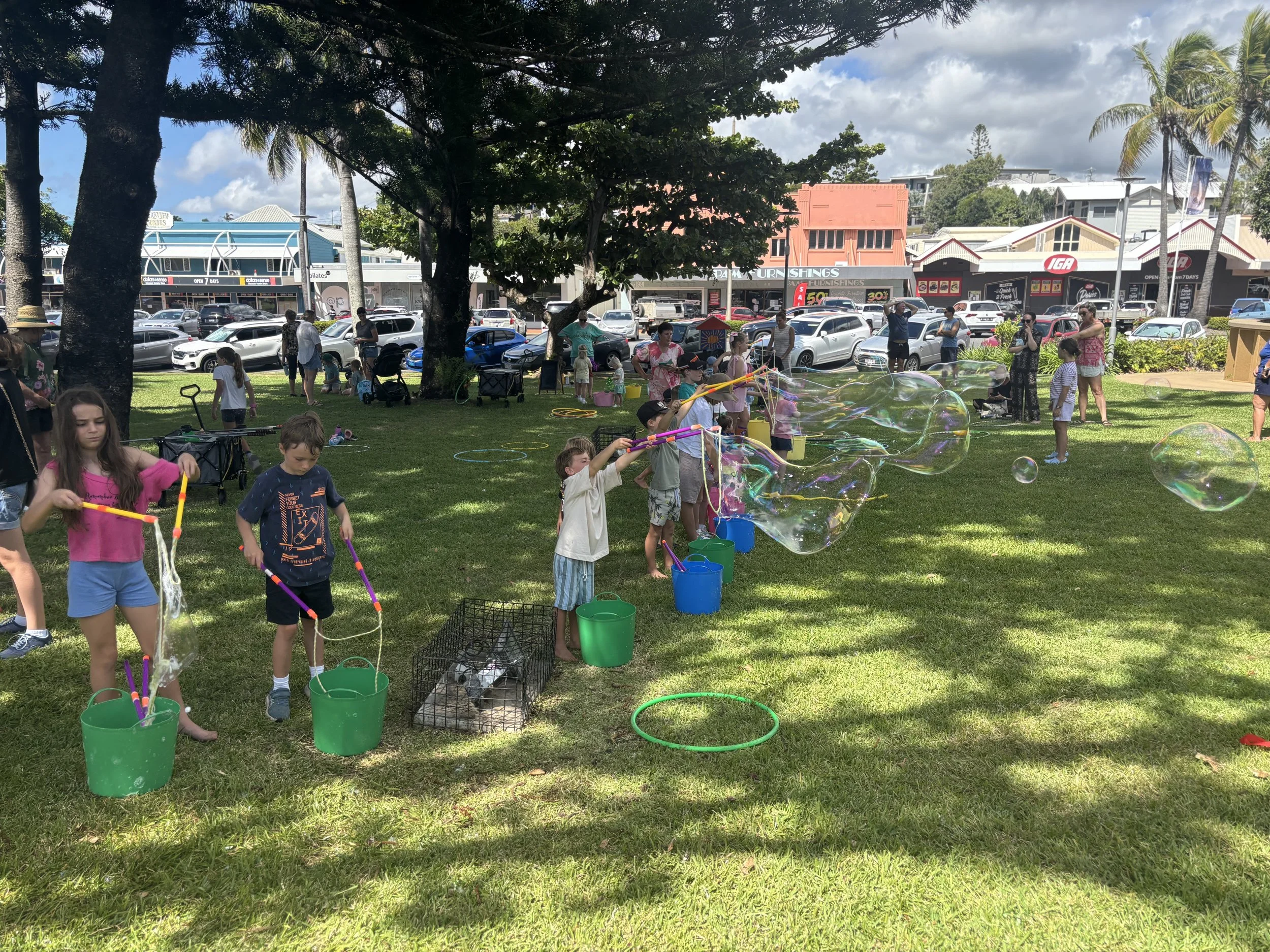 Kids enjoying a hands-on bubble workshop with large bubble wands