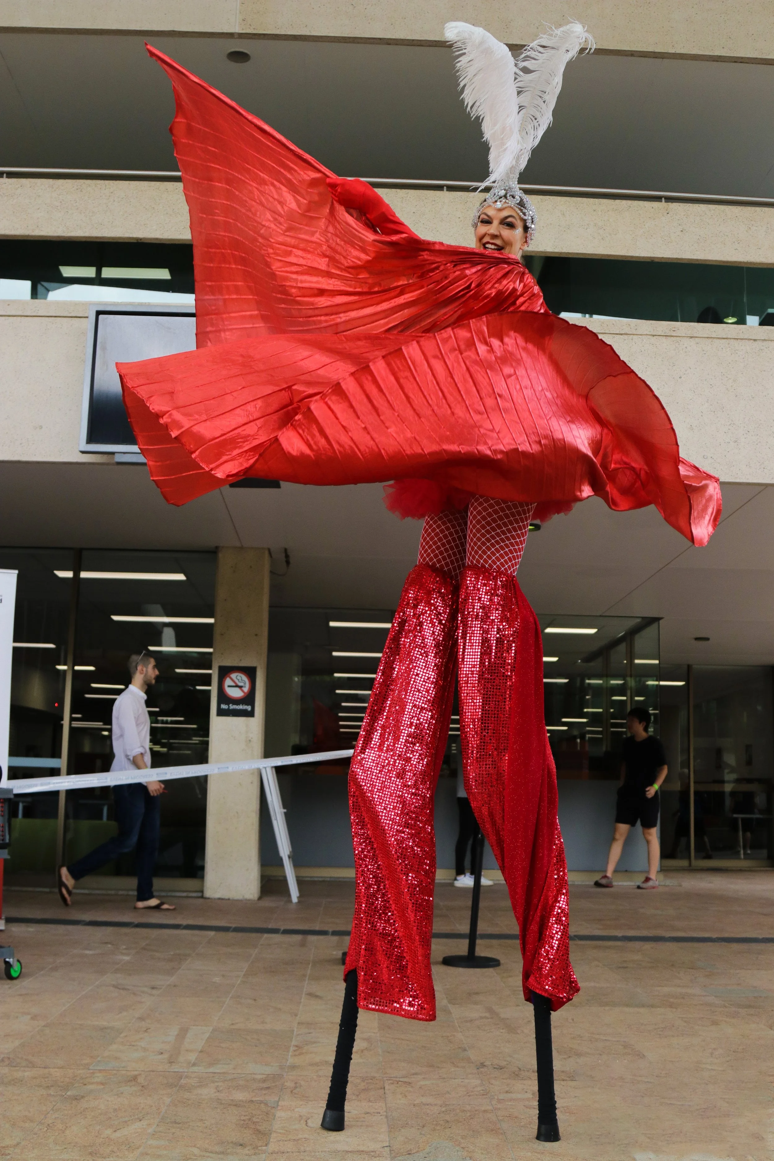 Eyes Up Events, Brisbane and Biggera Waters stilts walker roaming performers, all red costume with wings
