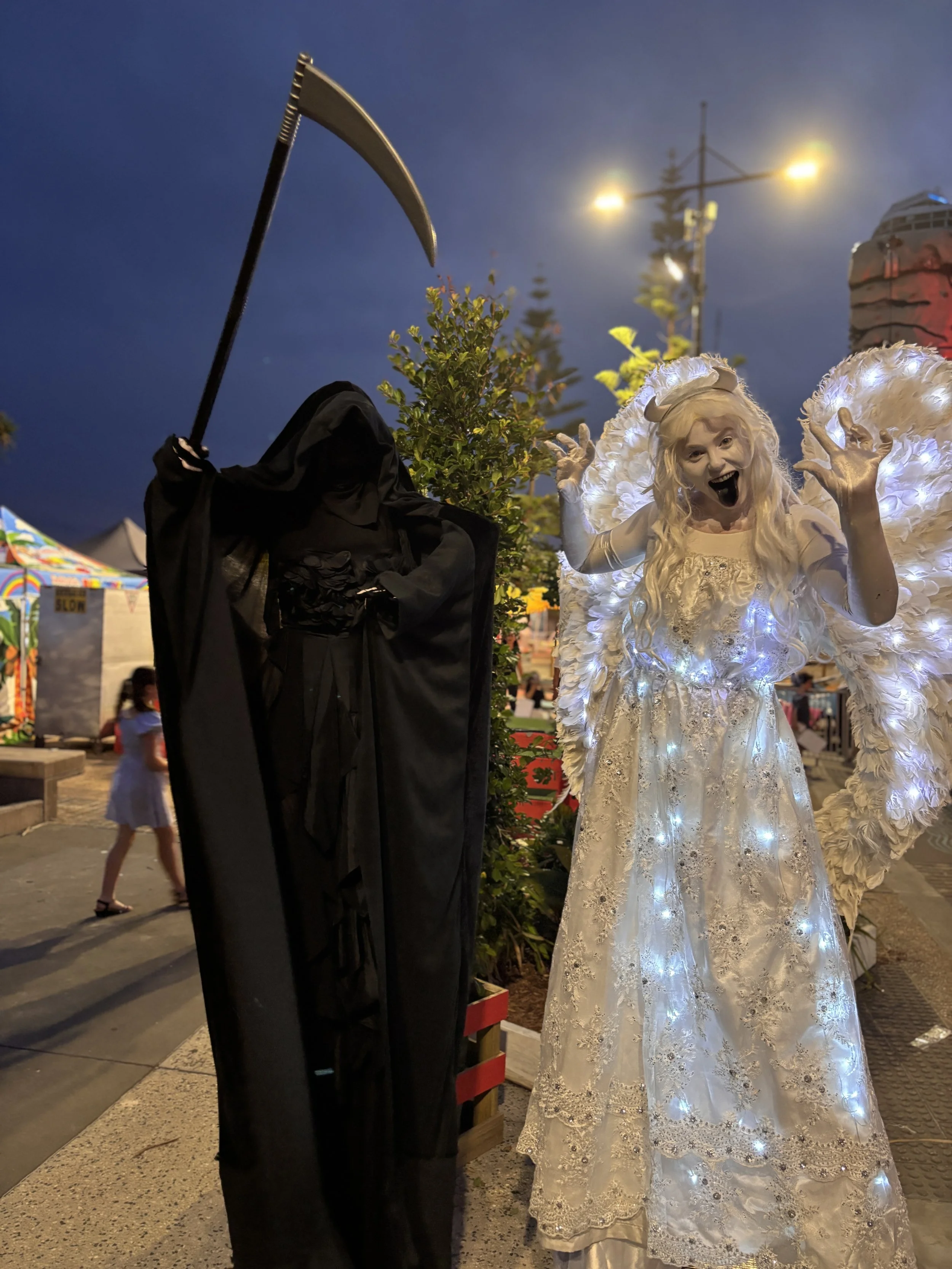 Spooky Halloween Grim Reaper costume entertaining festival crowd