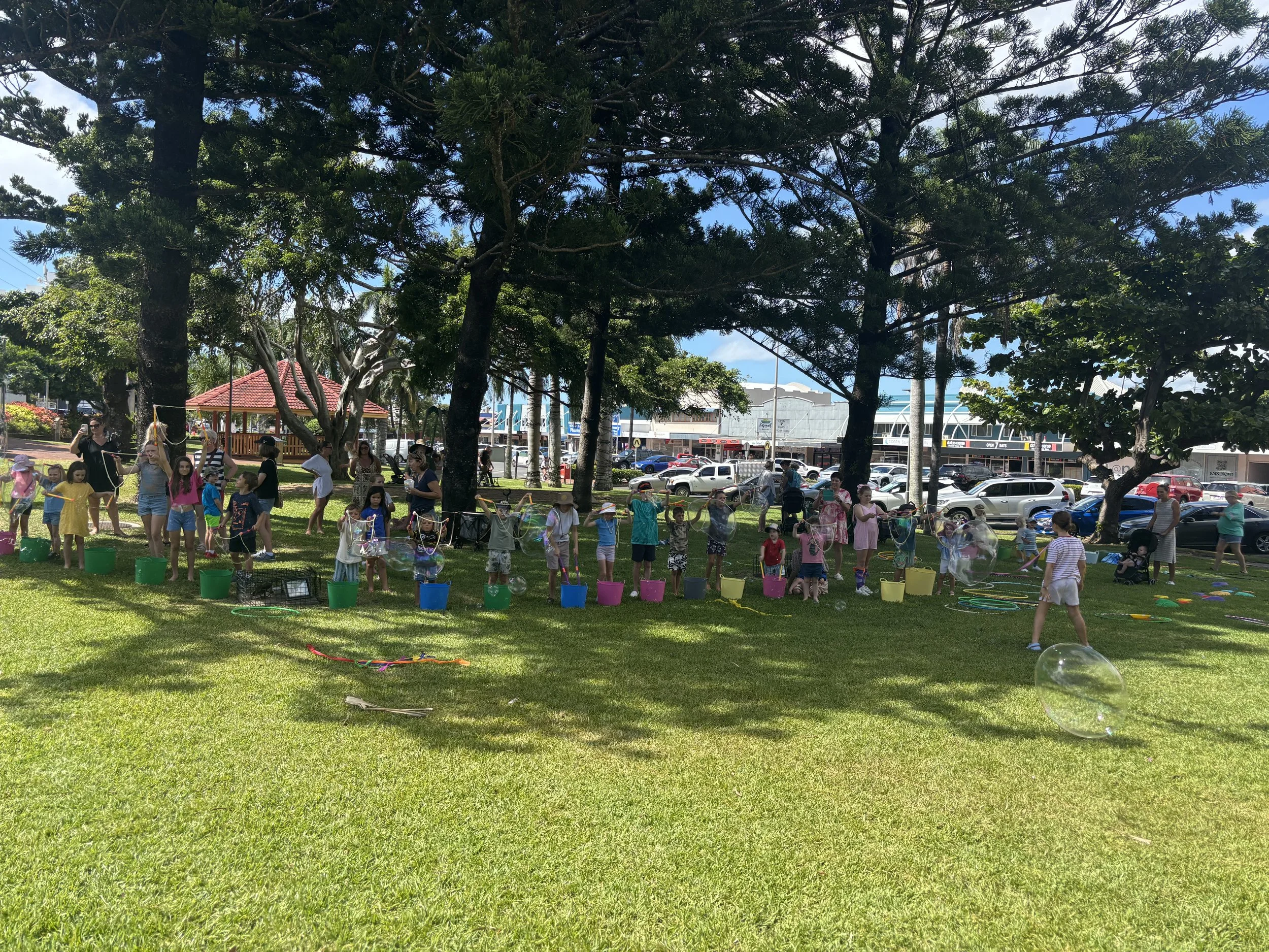 Children making giant bubbles at an outdoor bubble play space in Brisbane