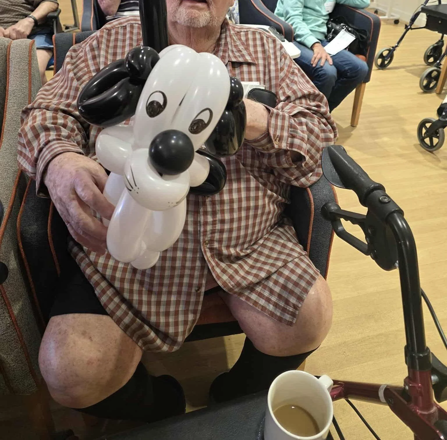 Balloon animal artist adding fun interaction to seniors social events on the Gold Coast.