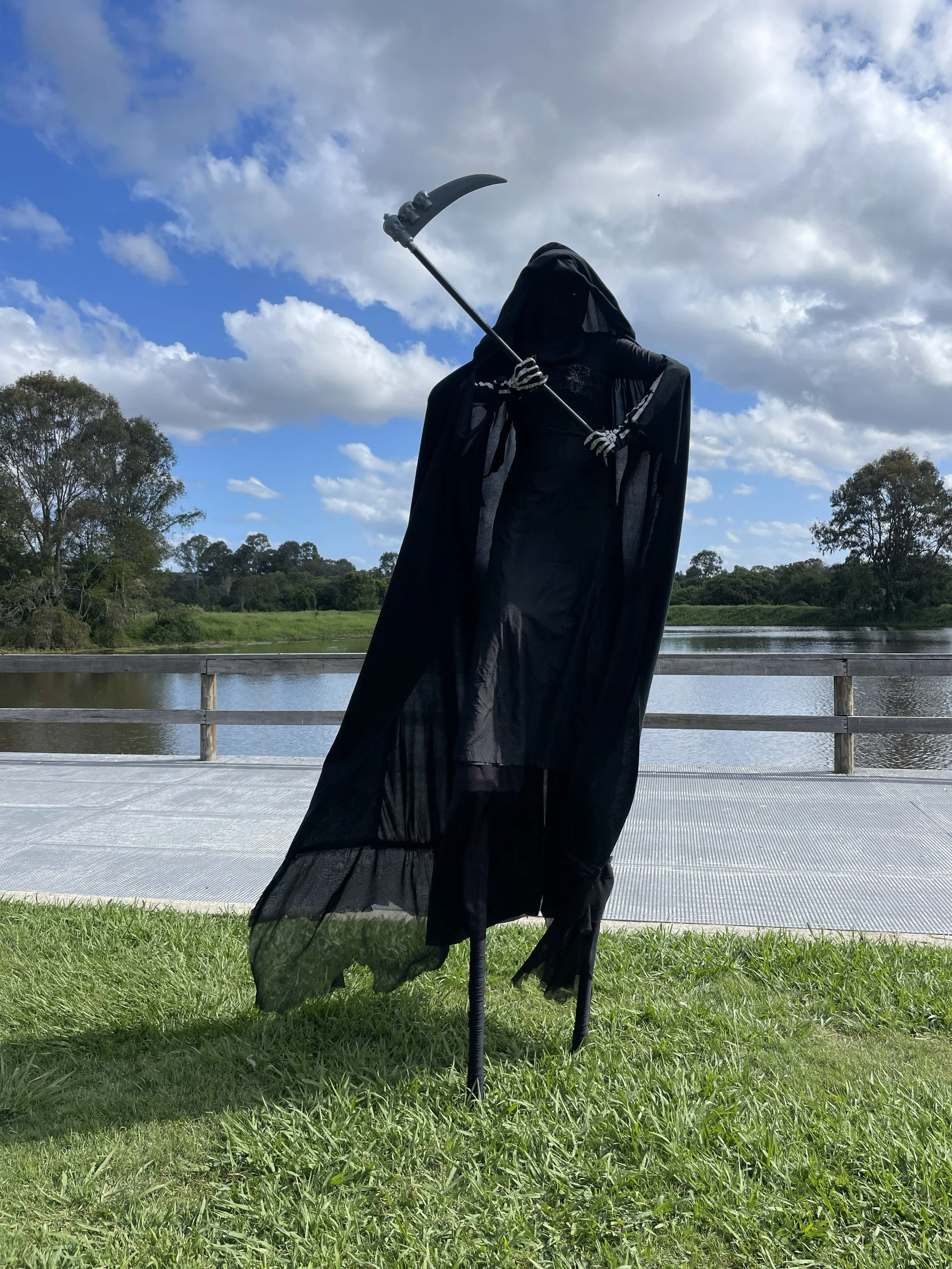 Grim Reaper roving character in black cloak performing at Brisbane event