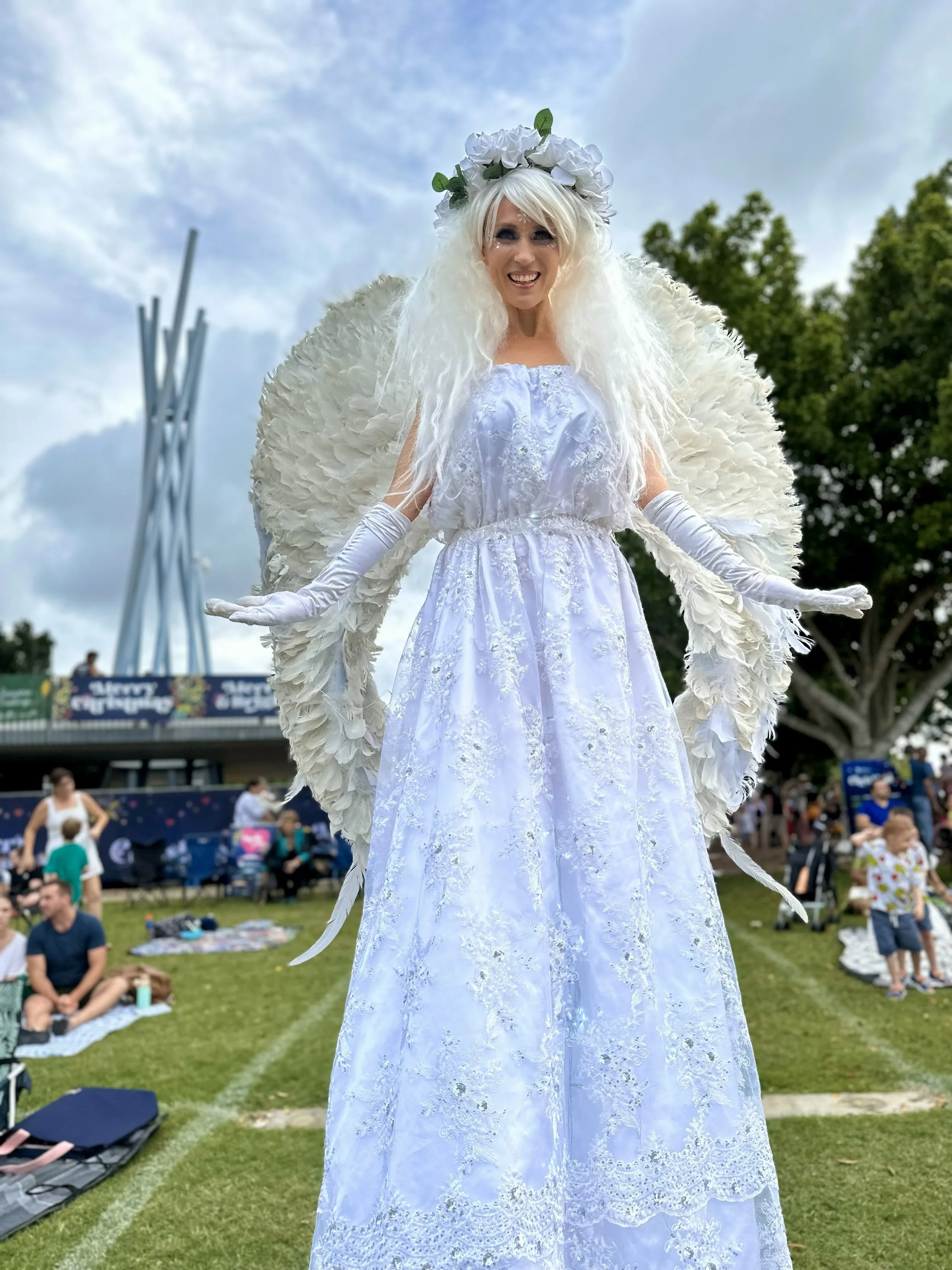 White angel roving character on stilts, perfect for soft, magical visual impact at Gold Coast event.