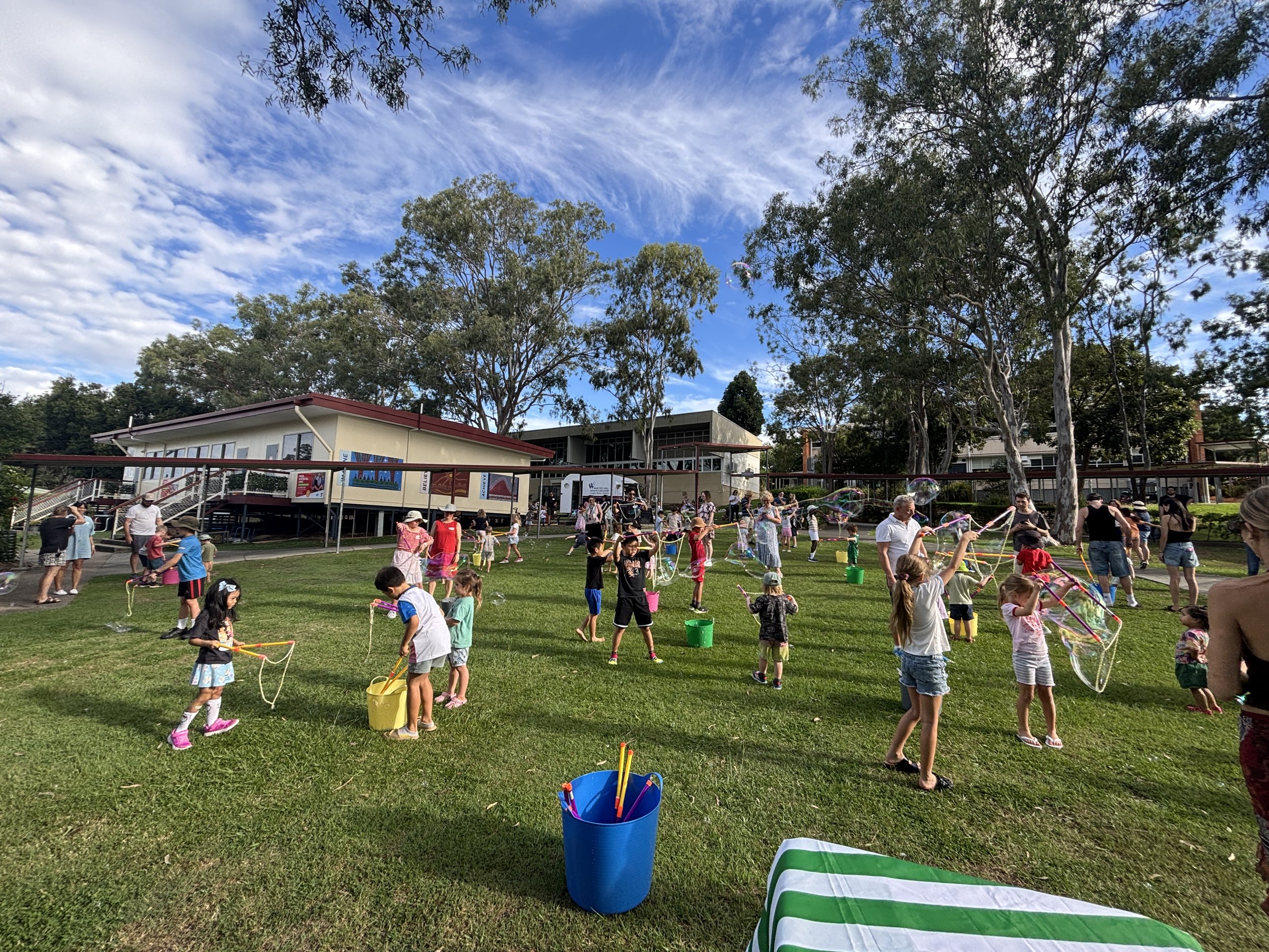 Kids bubble activity with bubble wands, buckets and floating giant bubbles