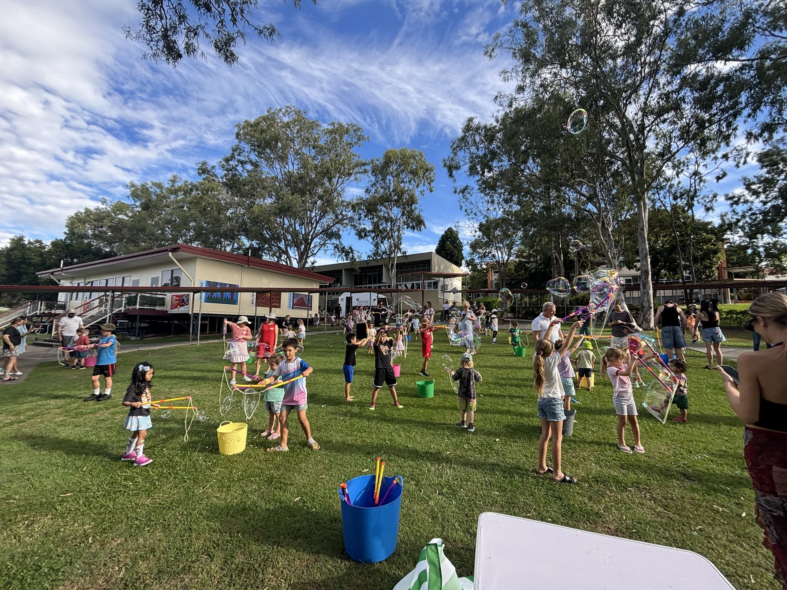 Interactive bubble play area with kids using bubble wands at a family event