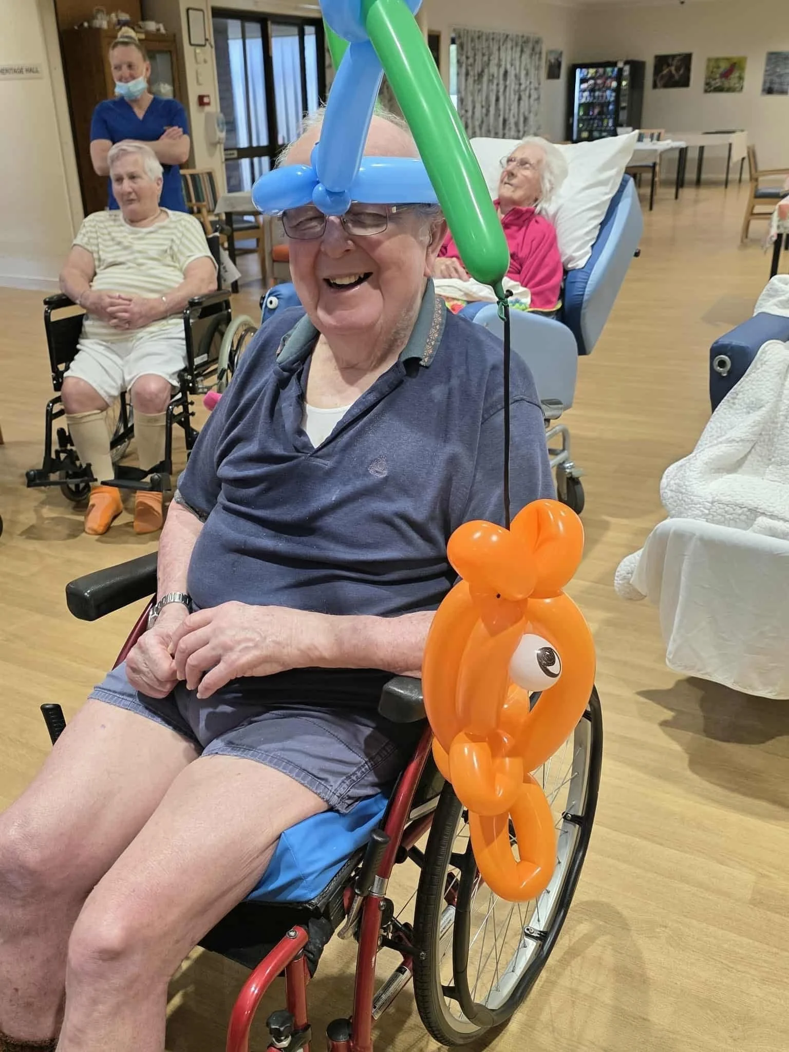 Balloon animal entertainment bringing joy and interaction to aged care residents in Brisbane.