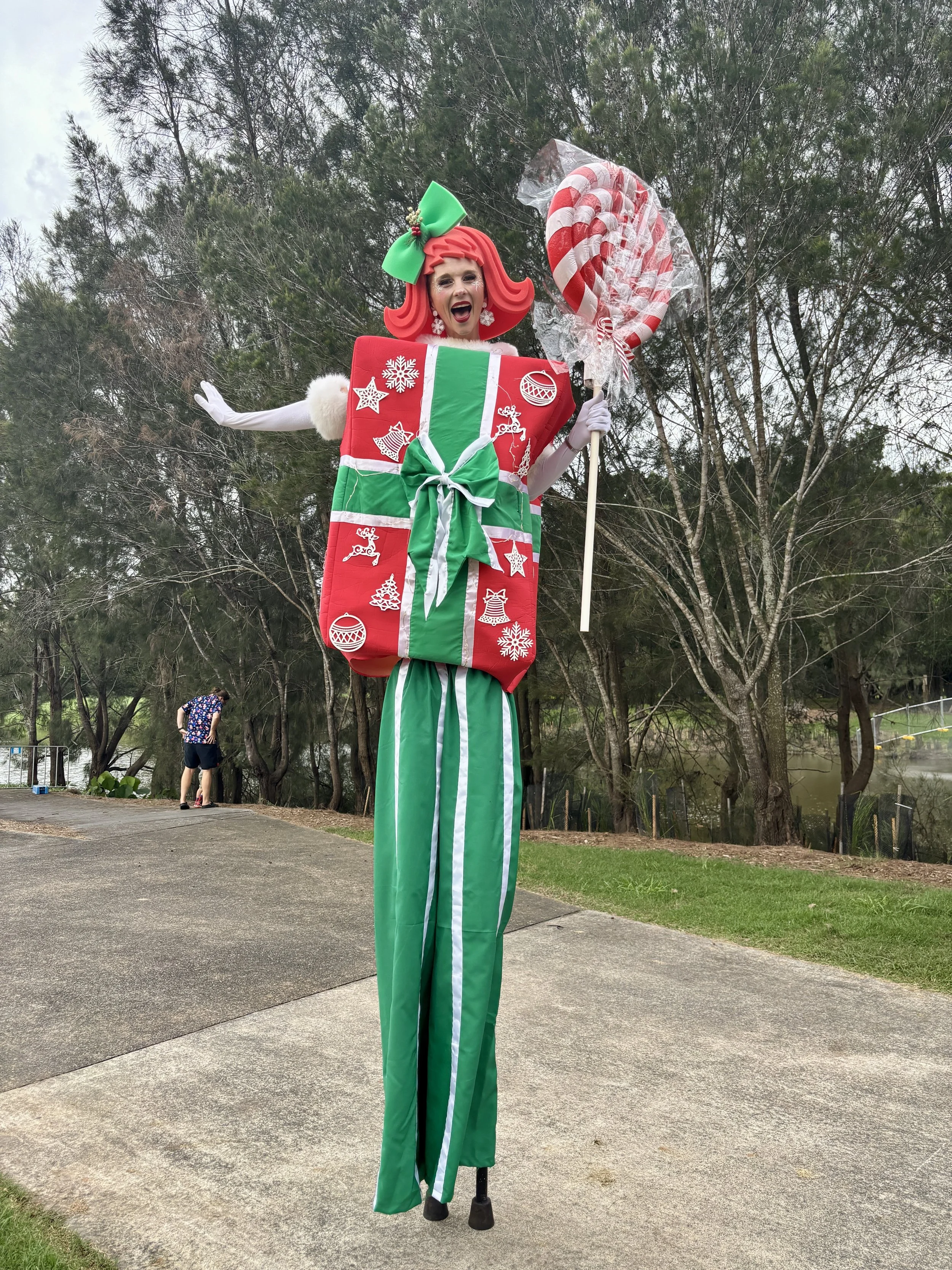 Performer inside gift box with big ribbon bow