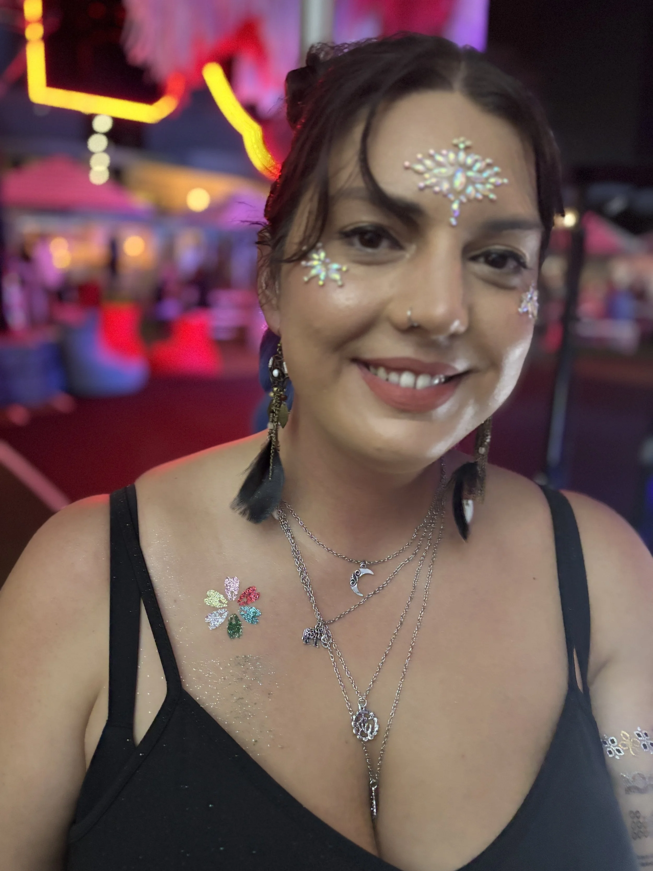 Bright glitter tattoo stall attracting crowds at Brisbane markets and festivals.