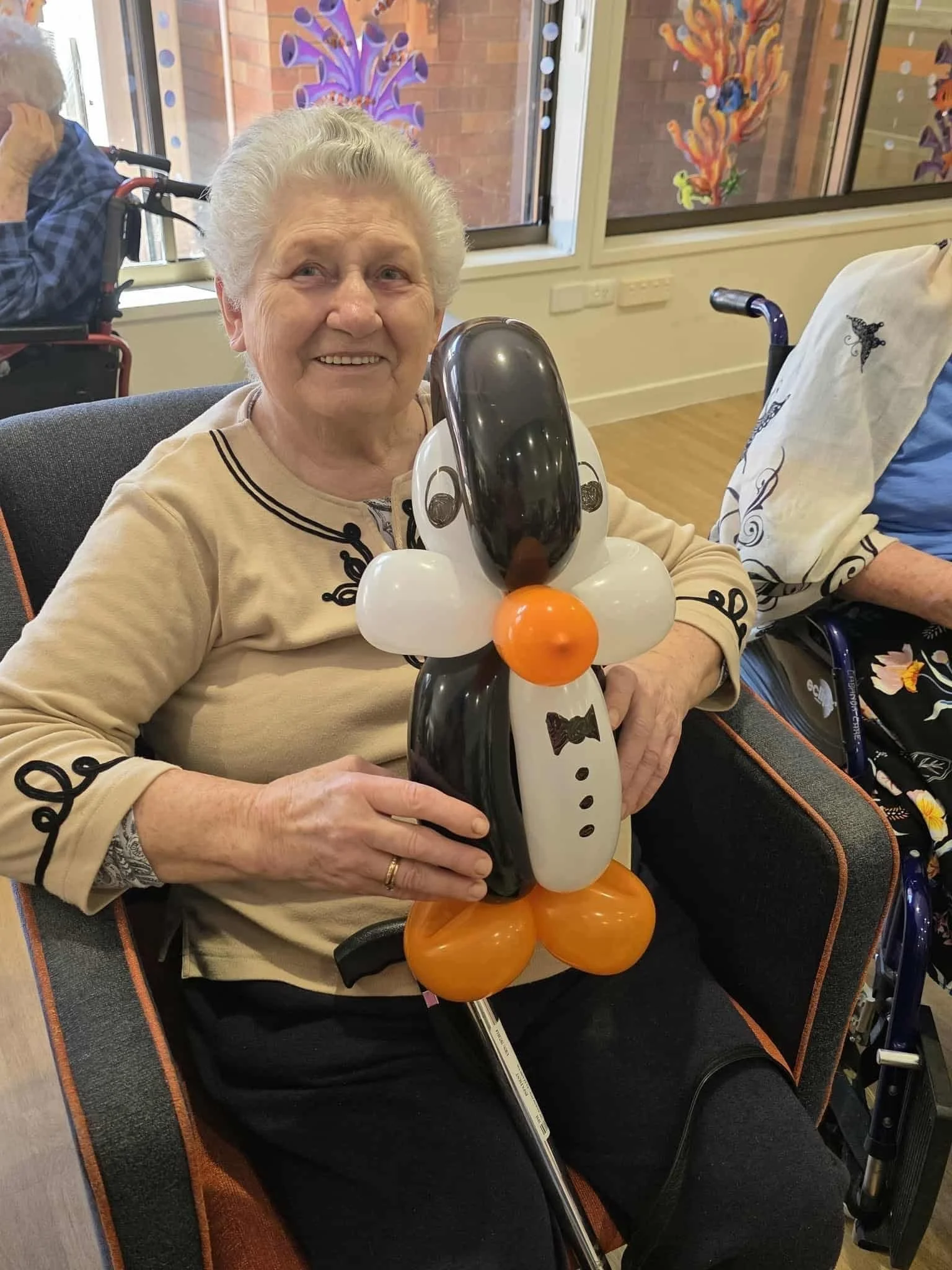 Balloon animal entertainer adding smiles to senior lifestyle and wellbeing events.