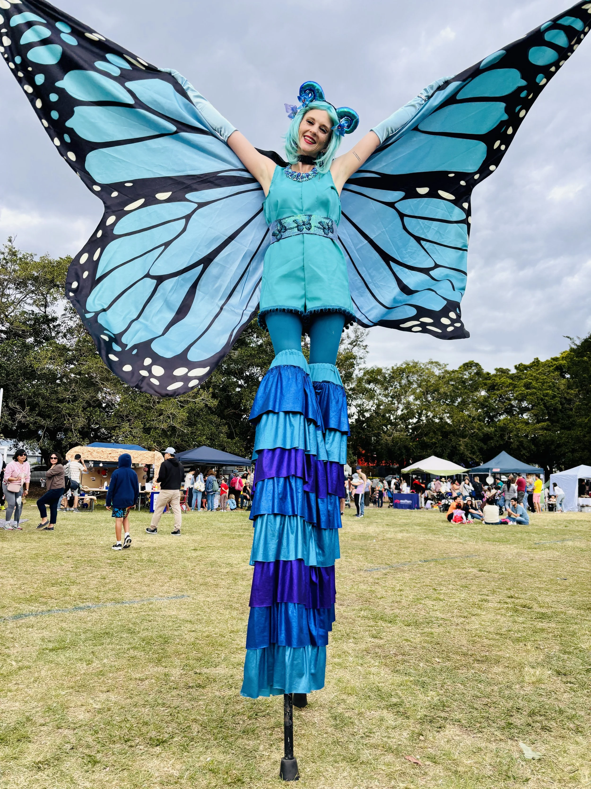 Eyes Up Events, blue butterfly with big wings stilt walker, nature themed event, roving entertainment Brisbane