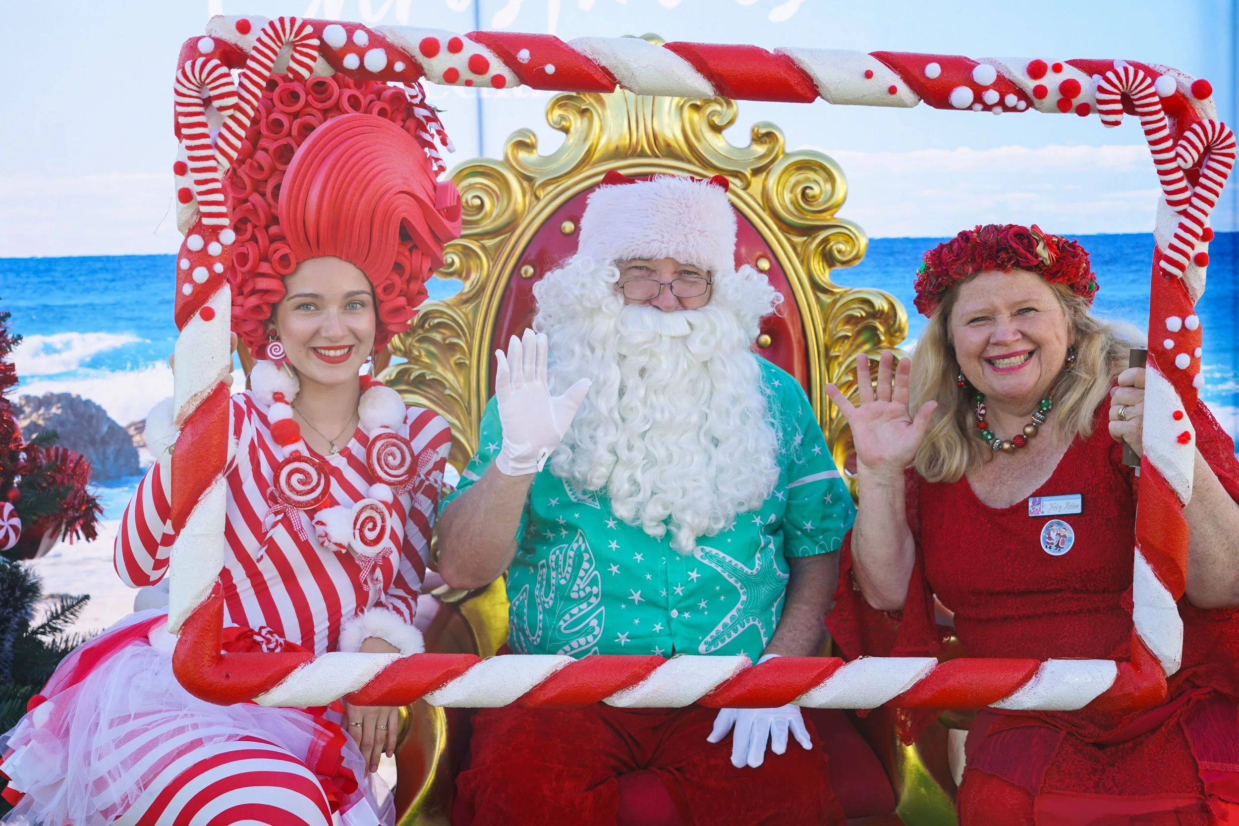 Guest posing inside a handmade themed photo frame with colourful roaming entertainer at family-friendly event.
