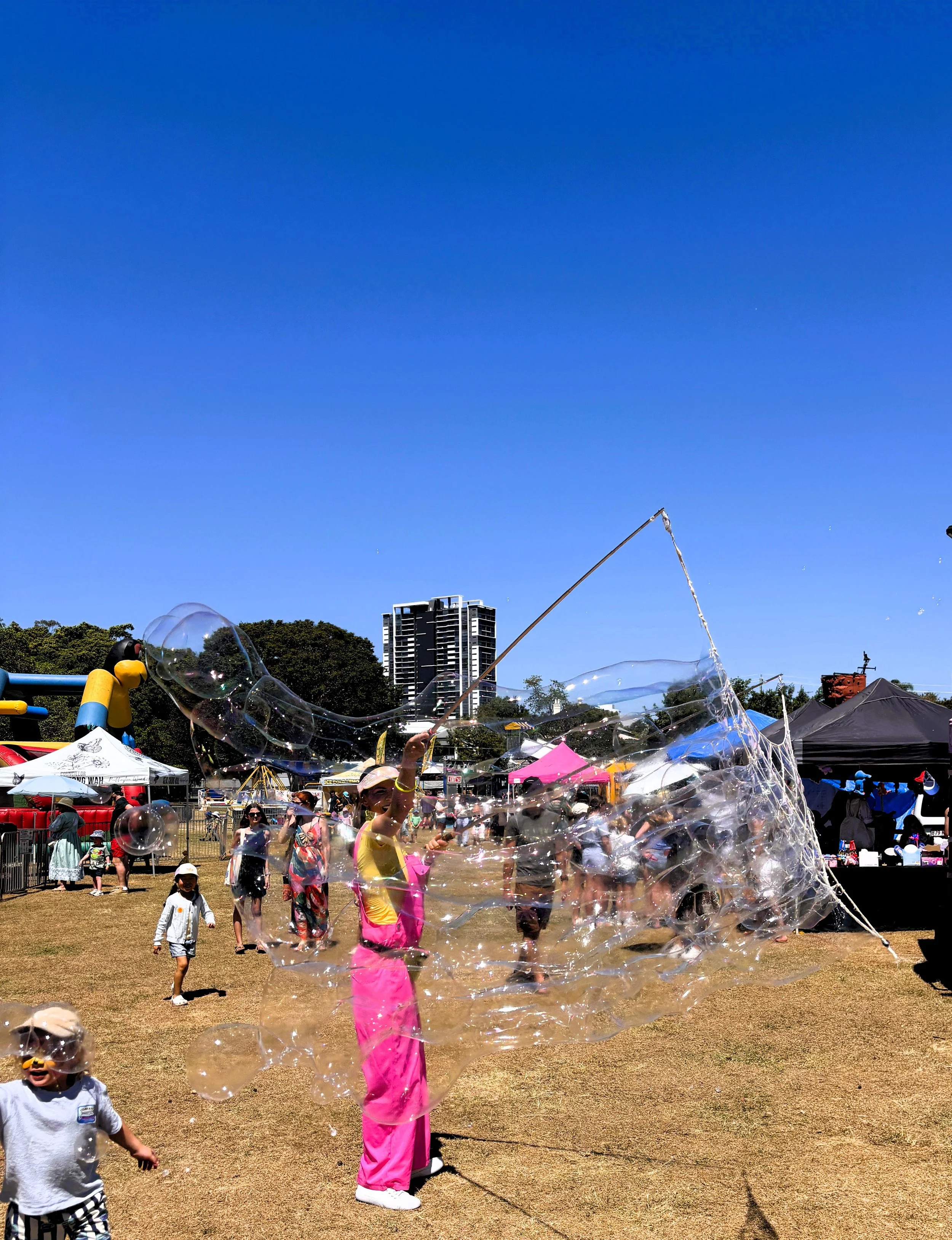 Kids playing in giant bubble zone with professional bubble mix and wands