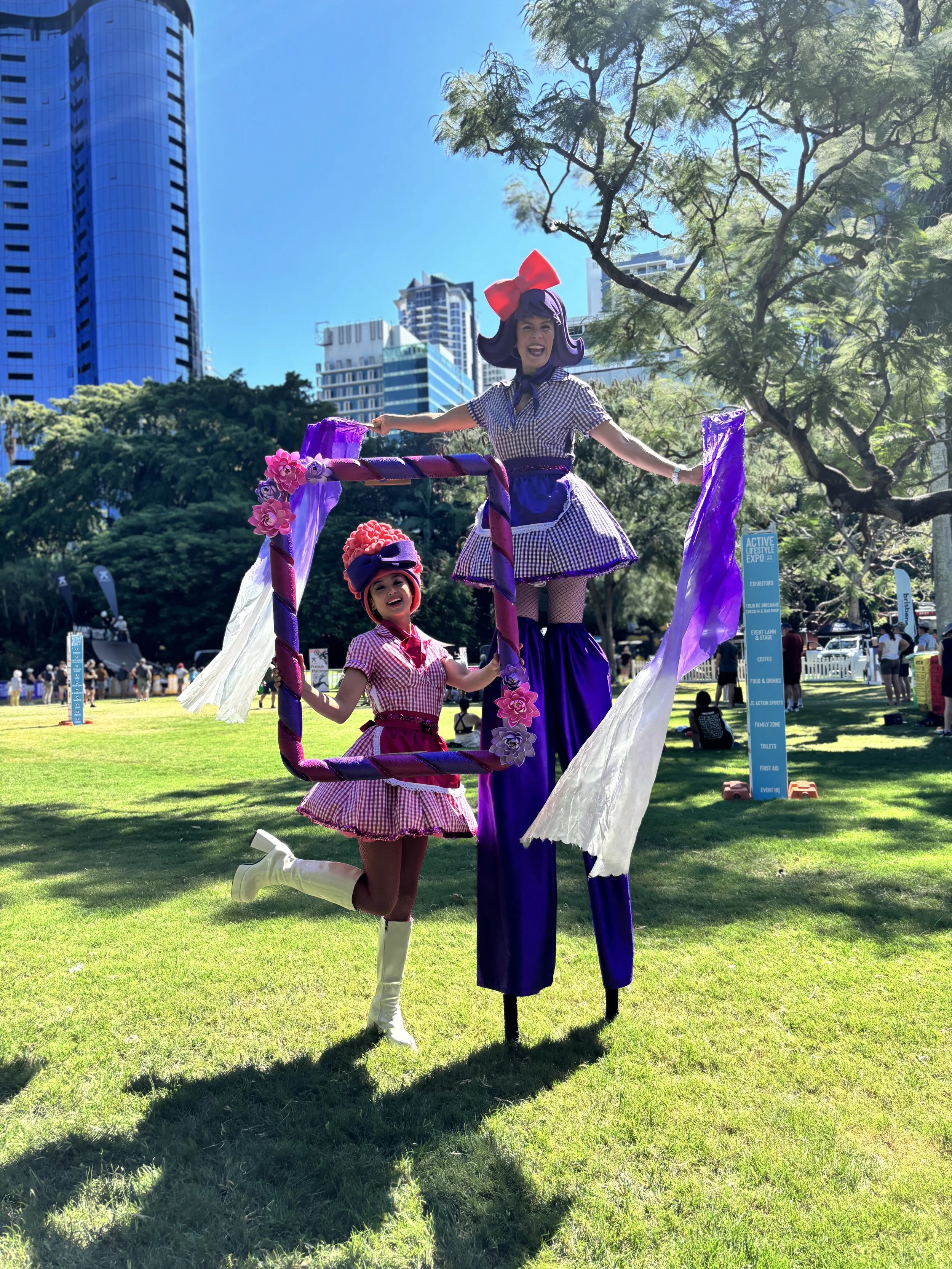 Colourful roving performer creating guest photo opportunities with custom-built decorative picture frame.