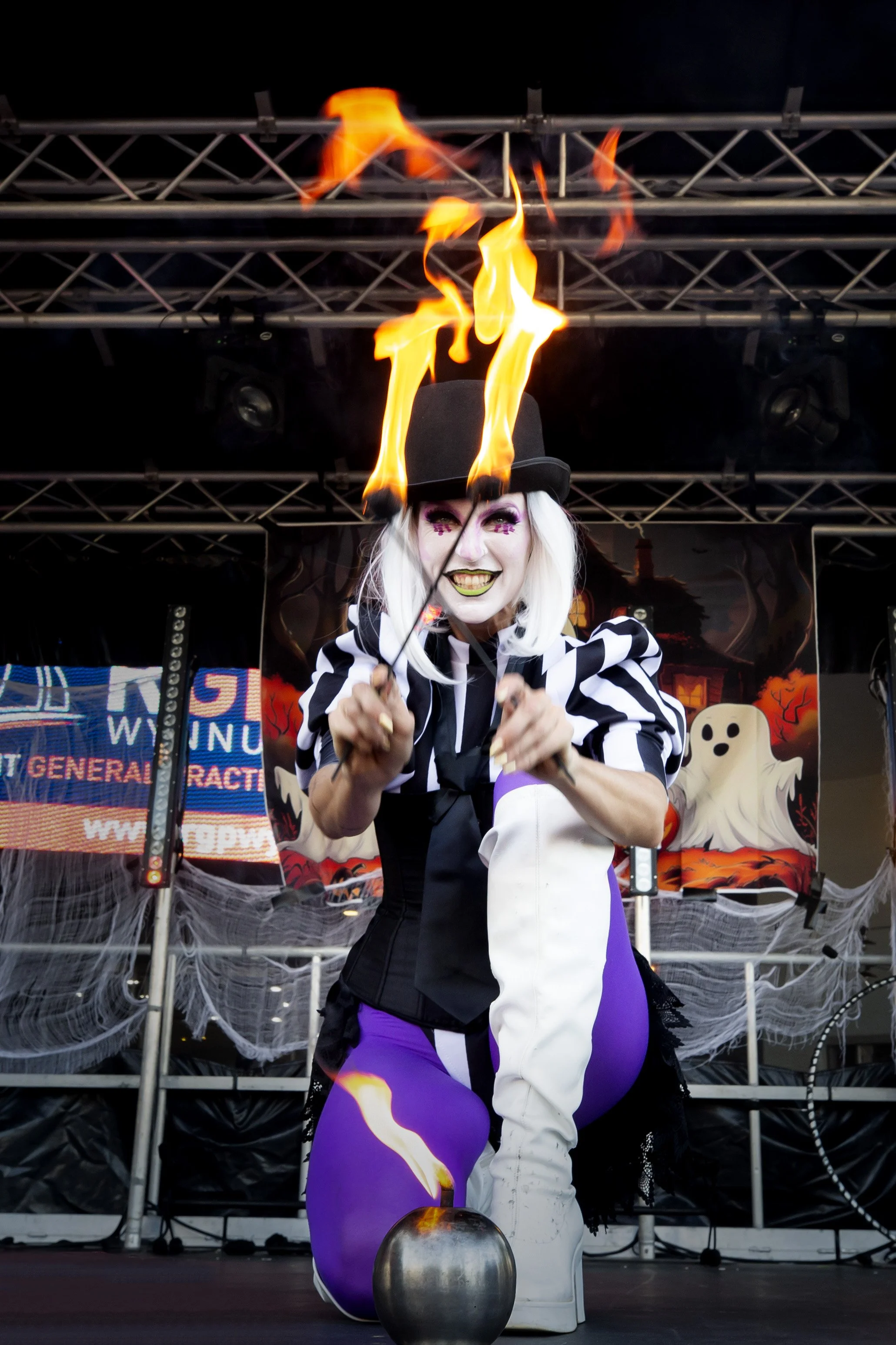 Halloween themed fire act with dramatic makeup and costume performance
