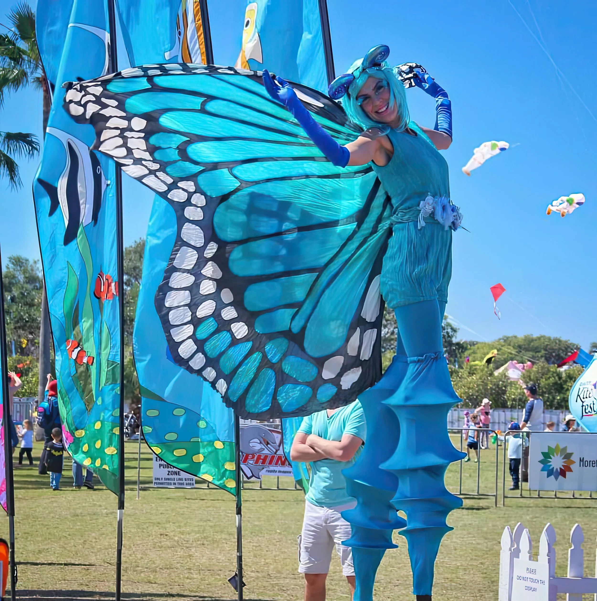 Eyes Up Events, blue butterfly with big wings stilt walker, nature themed event, roving entertainment Brisbane