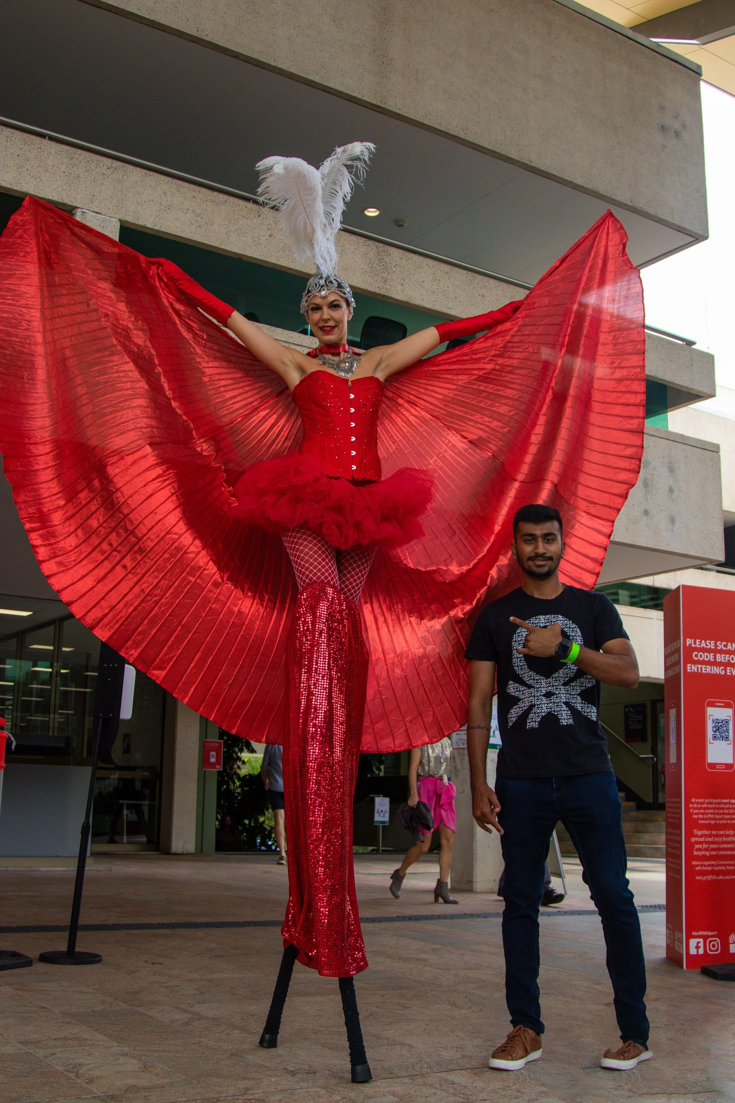 Eyes Up Events, Brisbane and Biggera Waters stilts walker roaming performers, all red costume with wings